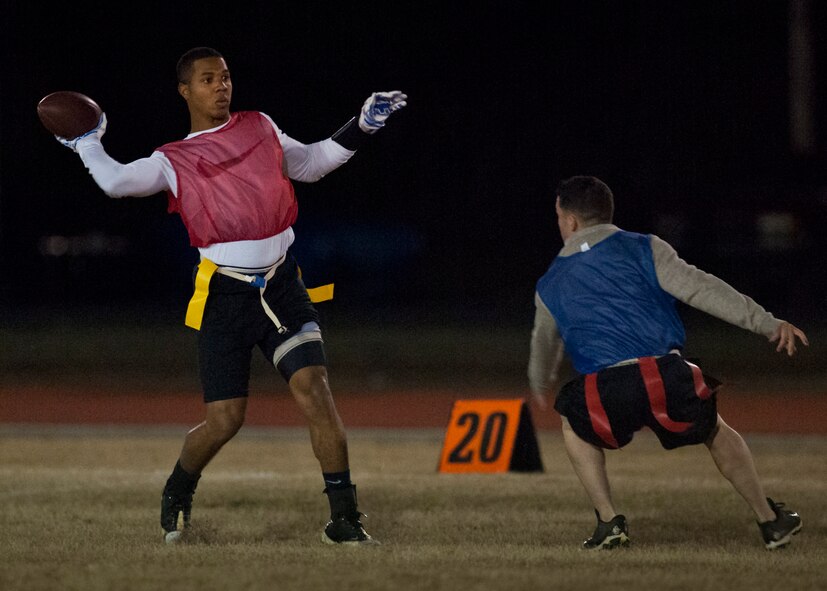 Savier Stephens, with the Armament Directorate team, passes the ball downfield as a 96th Security Forces Squadron defender moves in during the base intramural flag-football championship game Dec. 11 at Eglin Air Force Base, Fla.  The EB team won in an overtime battle 25-24 and repeated as base champions.  (U.S. Air Force photo/Samuel King Jr.)