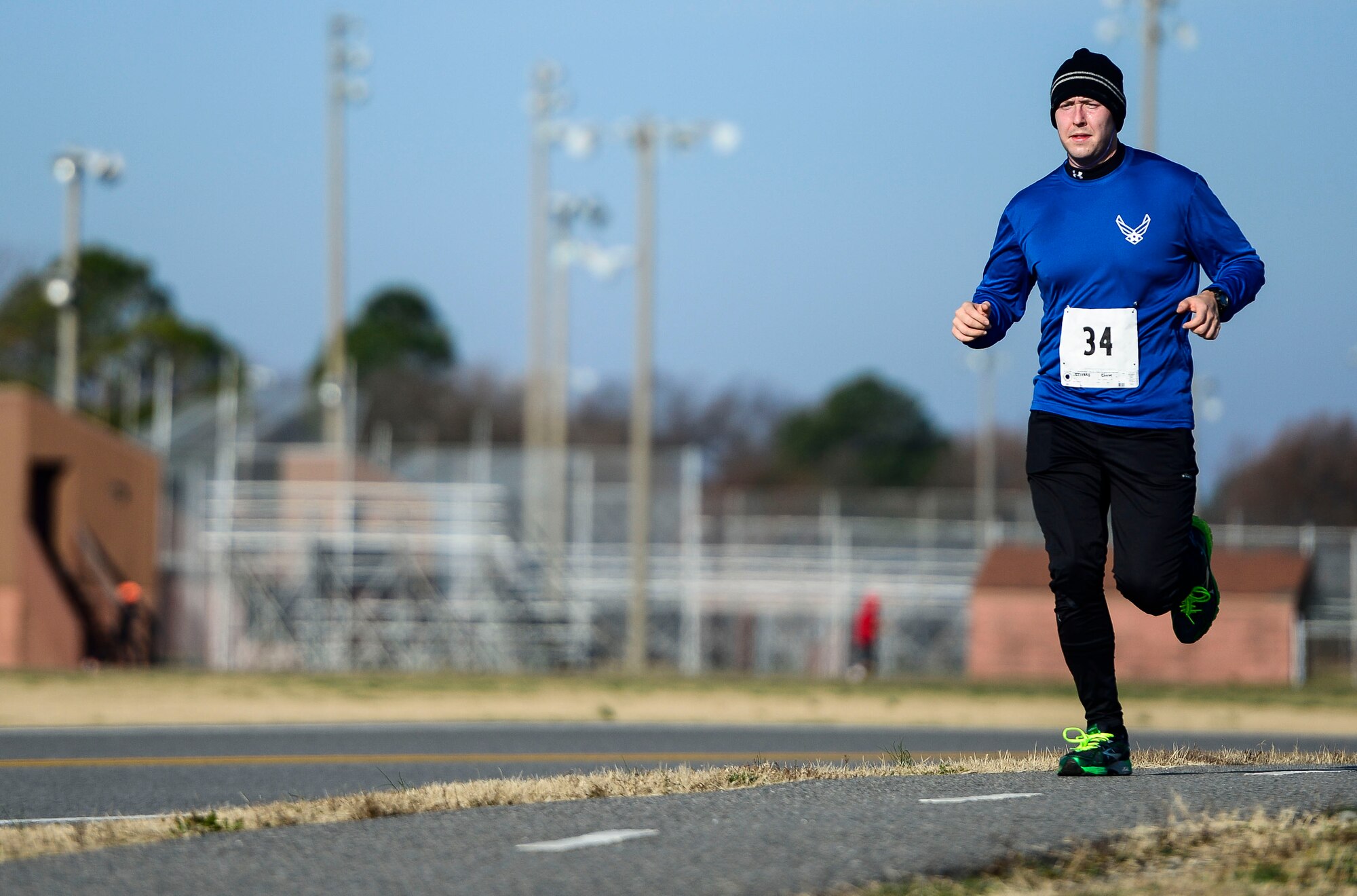 James Darden of Newport News, Va., runs past the flight line during the 5th annual Race Round’ the Base at Langley Air Force Base, Va., Dec. 13, 2014. Trophies were awarded to the 1st place male and female runners in the 10k and 5k races.  (U.S. Air Force photo by Senior Airman Kayla Newman/Released) 