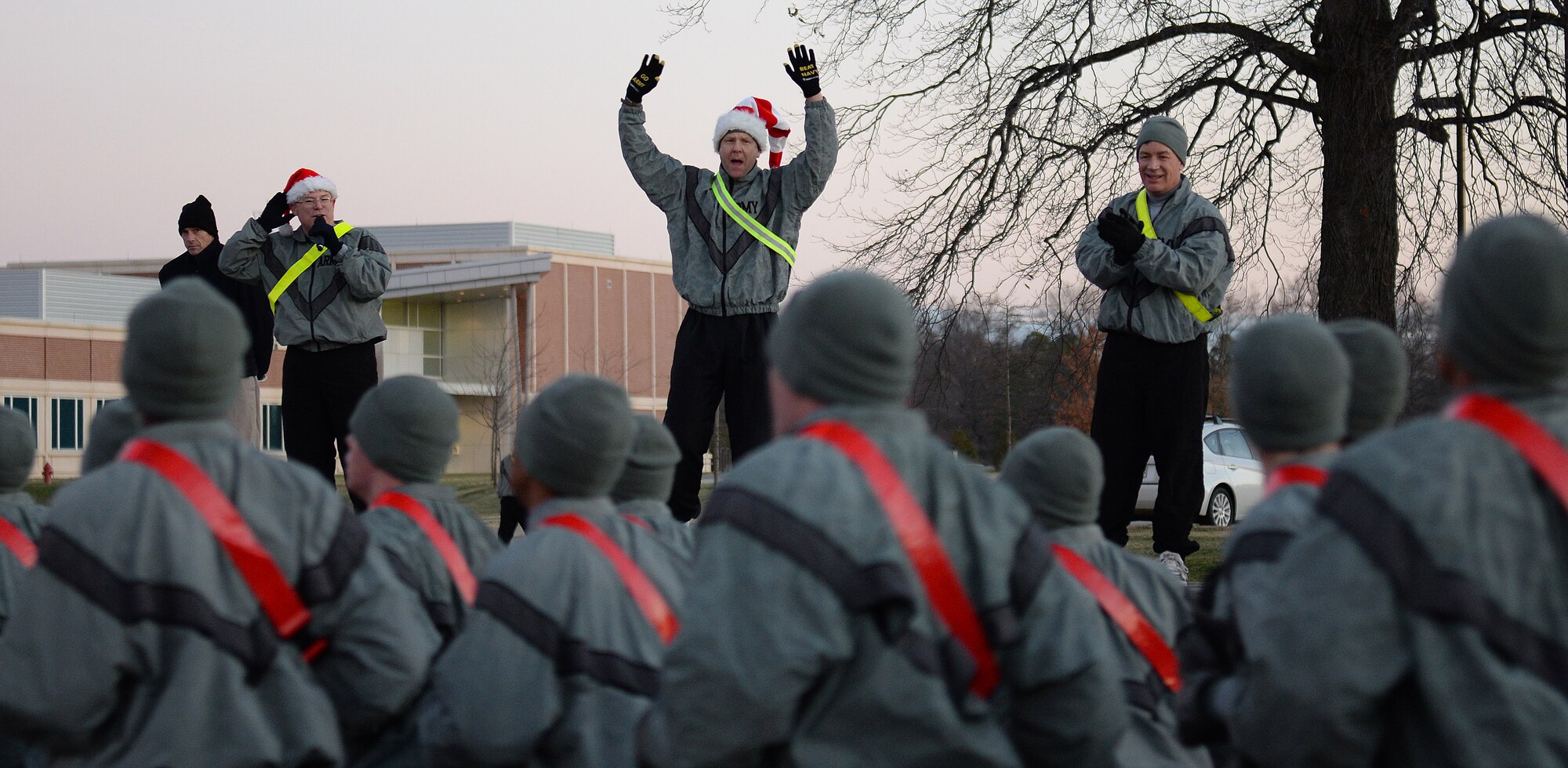 U.S. Army Senior leaders cheer on more than 2,500 Soldiers during the 15th annual Holiday Run at Fort Eustis, Va., Dec. 12, 2014. Leaders participated in the run and cheered on participants until the last unit crossed the finish line. . (U.S. Air Force photo by Staff Sgt. Teresa J. Cleveland/Released)