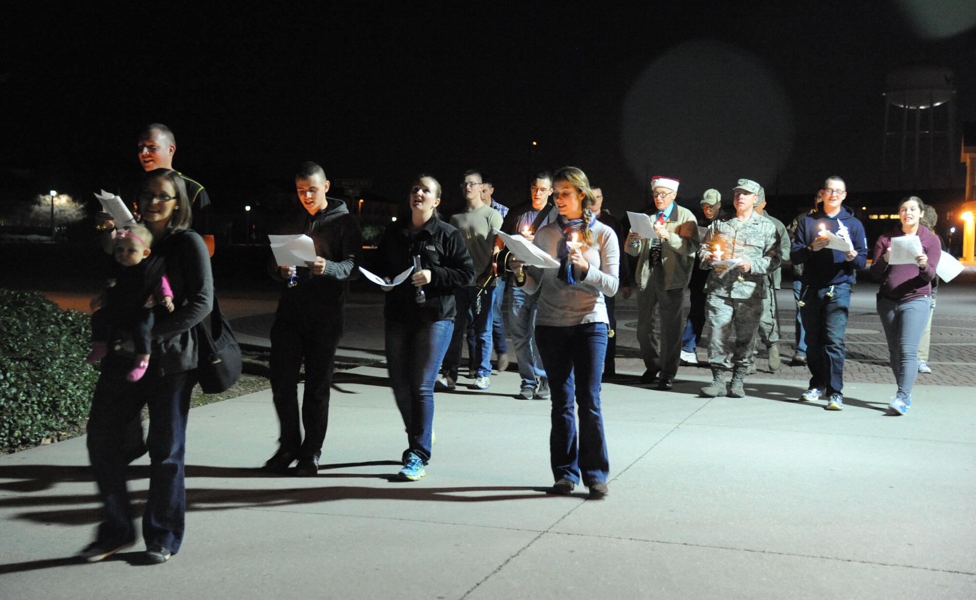 Keesler personnel make their way around the Triangle Courtyard singing Christmas carols Dec. 12, 2014, at Keesler Air Force Base, Miss.  Following the Christmas caroling, hot chocolate and cookies were available to everyone in attendance. (U.S. Air Force photo by Kemberly Groue)