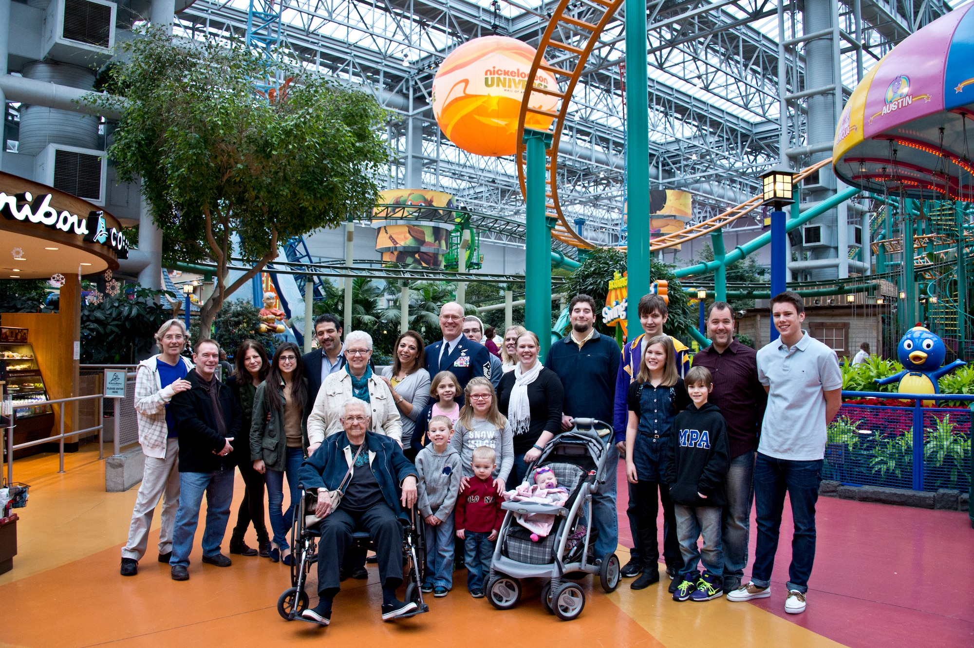 First Sgt. Robert Renning of 133rd Airlift Wing poses for a family photo after he surprised his longtime girlfriend by proposing during the Mall of America’s Holiday for Heroes, Dec 14, 2014.  Renning is the Wing’s Outstanding First Sergeant of 2014 and became famous this summer for his life saving efforts of recusing a man from a burning vehicle.   (U.S. Air National Guard Photo by Tech. Sgt. Lynette Olivares / Released)