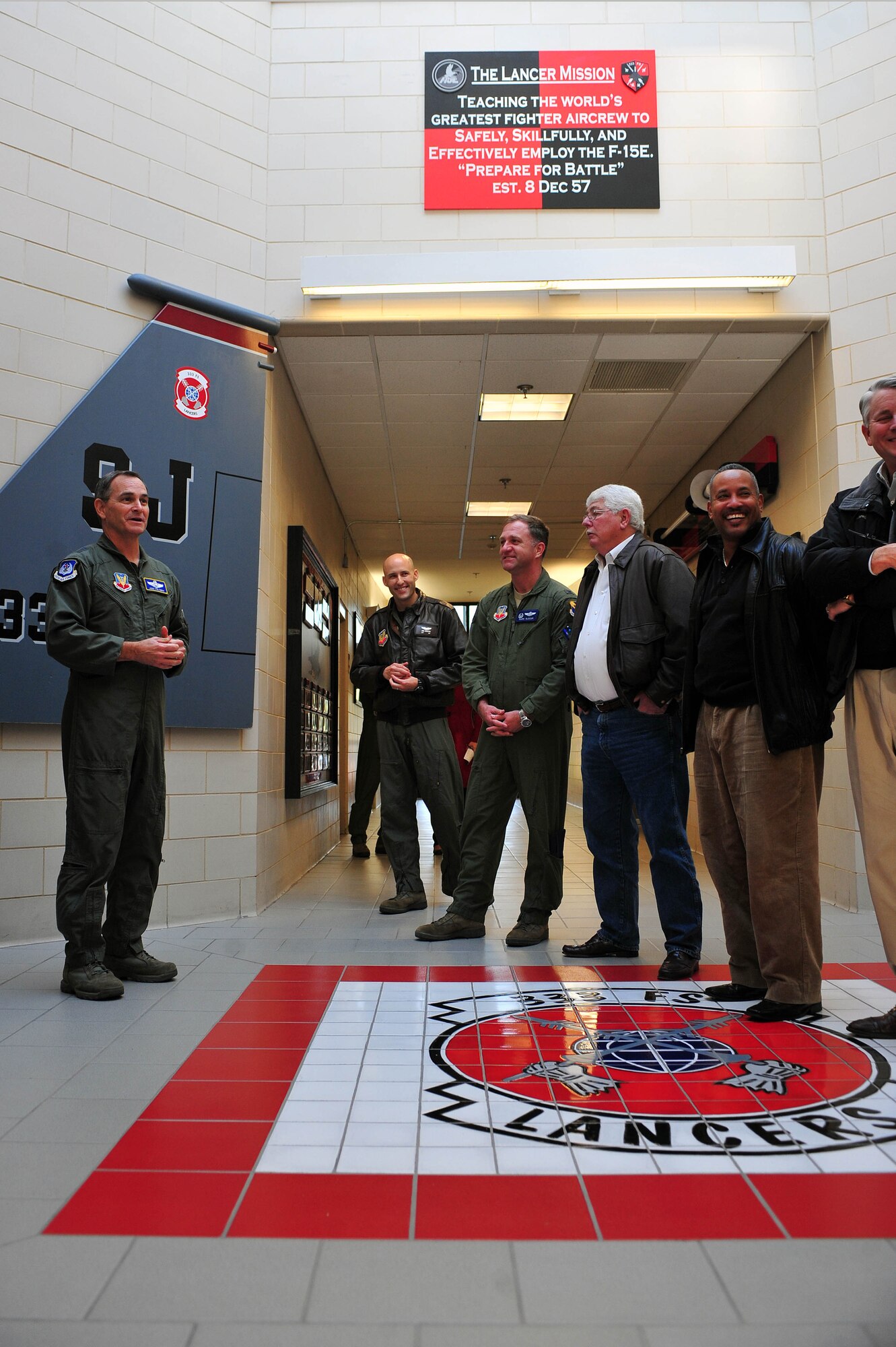 Maj. Gen. H.D. Polumbo Jr., Ninth Air Force commander, speaks with Col. Mark Slocum, 4th Fighter Wing commander, and members of the base military affairs committee before a pre-flight briefing for exercise Razor Talon at Seymour Johnson AFB, North Carolina, Dec. 5, 2014. Polumbo was accompanied by Mr. Vince Pavkov, Ninth AF honorary commander, during his visit. (U.S. Air Force photo/Senior Airman John Nieves Camacho)