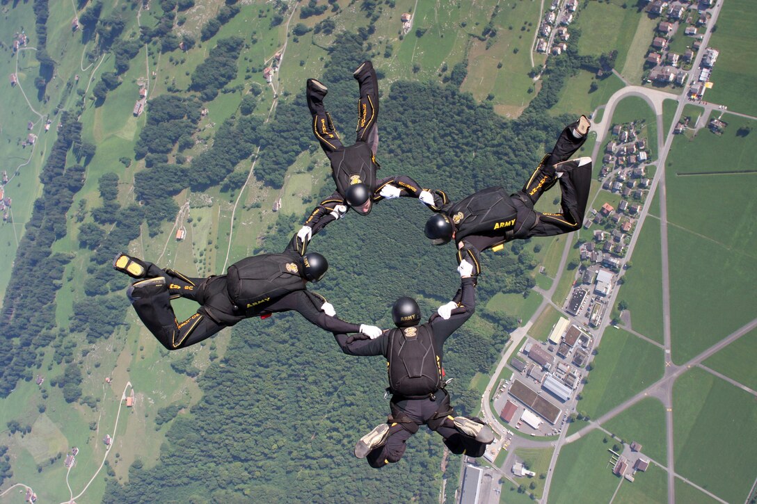 A four-person formation of U.S. Army Golden Knights parachutists jumps over Bouchs, Switzerland, at 2010 World Military Parachuting Championship, July 16, 2010. The U.S. Army Golden Knights parachute team is scheduled to perform during the 2015 Dakota Thunder Air Show. 