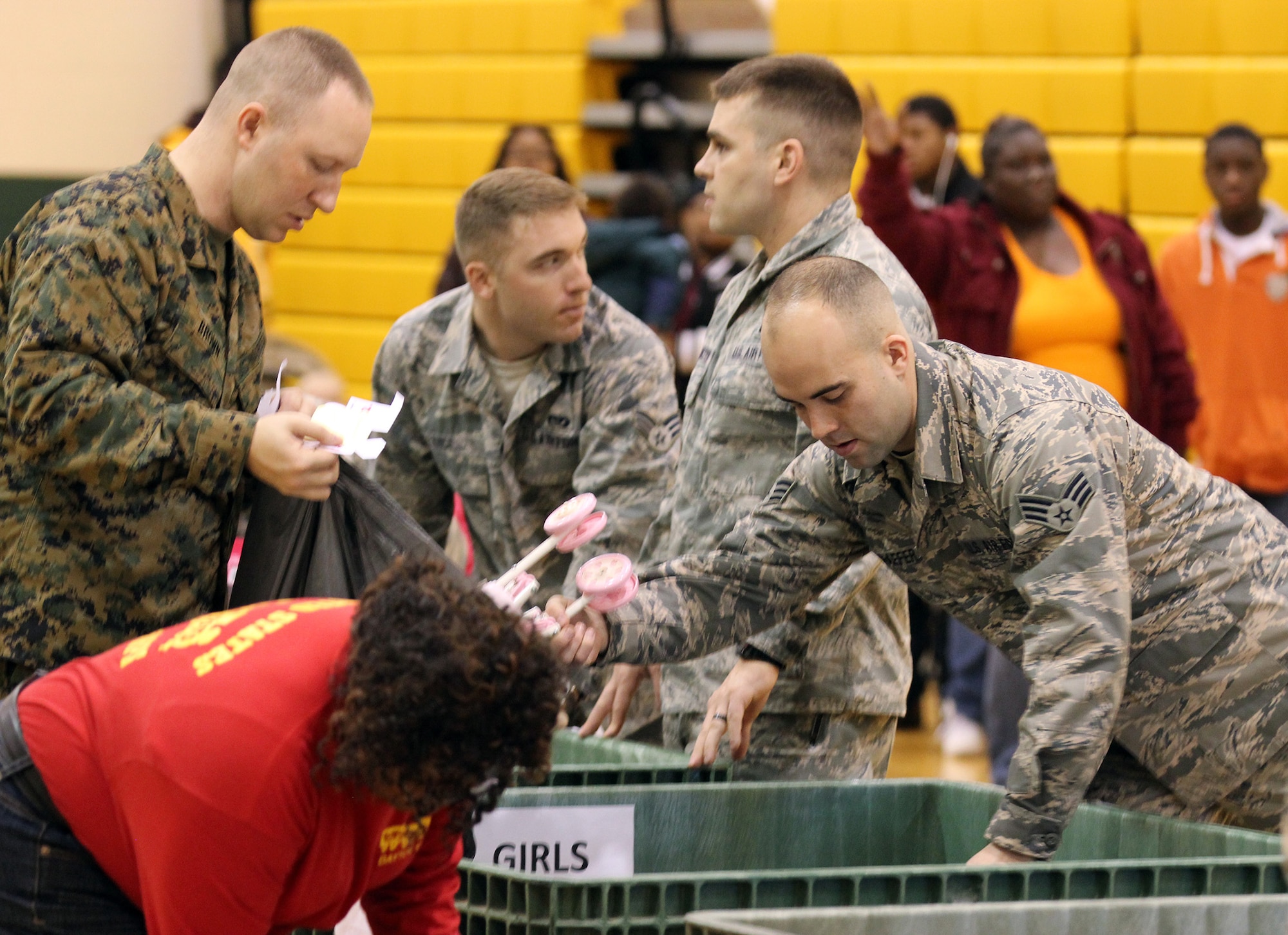 DAYTON, Ohio – Approximately 30 Reserve Airmen and Reserve Force Marines from the 445th Airlift Wing and the Military Police Company C, Wright-Patterson Air Force Base, Ohio handed out toys to recipients at the Toys for Tots program held at Westwood Elementary School, Dayton, Ohio Dec. 6, 2014. The mission of the U. S. Marine Corps Reserve Toys for Tots Program is to collect new, unwrapped toys during October, November and December each year, and distribute those toys as Christmas gifts to less fortunate children in the community in which the campaign is conducted. Over its life span, the Marine Toys for Tots Program distributed over 469 million toys to over 216 million less fortunate children. (U.S. Air Force photo/Tech. Sgt. Patrick O'Reilly)