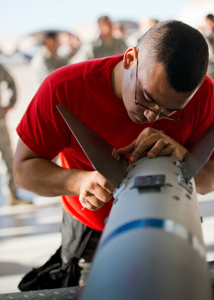 Senior Airman Christopher Mann, from 96th Aircraft Maintenance Squadron Red, secures the fins onto an AIM-120 during the 96th Maintenance Group’s quarterly weapons load crew competition Dec. 5 at Eglin Air Force Base, Fla.  The Red F-15 team won out over the 96th Aircraft Maintenance Squadron’s Blue F-16 team.  (U.S. Air Force photo/Samuel King Jr.)