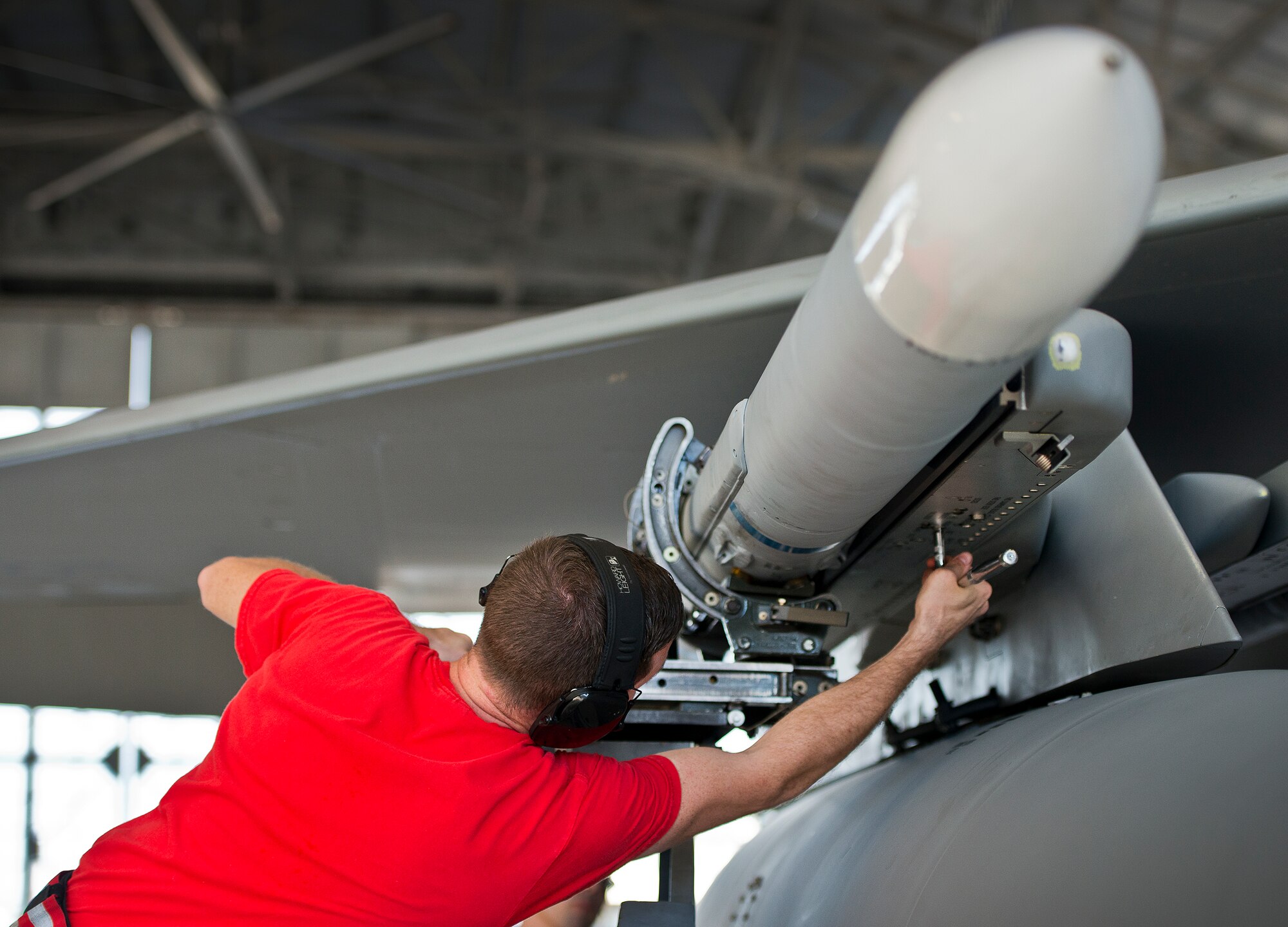 Staff Sgt. Stephen Presley, from 96th Aircraft Maintenance Squadron Red, reaches out to secure the AIM-120 during the 96th Maintenance Group’s quarterly weapons load crew competition Dec. 5 at Eglin Air Force Base, Fla.  The Red F-15 team won out over the 96th Aircraft Maintenance Squadron’s Blue F-16 team.  (U.S. Air Force photo/Samuel King Jr.)