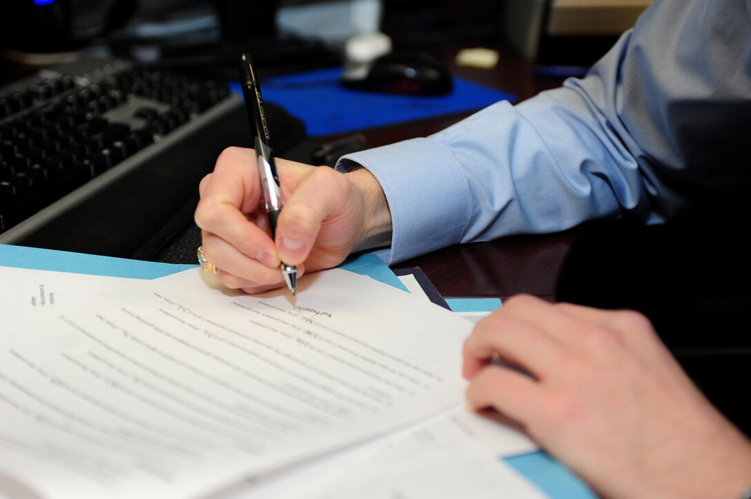 Mathew Engelbaum, 633rd Air Base Wing Legal Office intern, reviews private organizations’ programs at Langley Air Force Base, Va., Dec. 12, 2014. As a participant of the Air Force legal internship program at Langley AFB, Engelbaum was able to see what it is like to work in a military installation legal office. (U.S. Air Force photo by Airman 1st Class Areca T. Wilson/Released) 