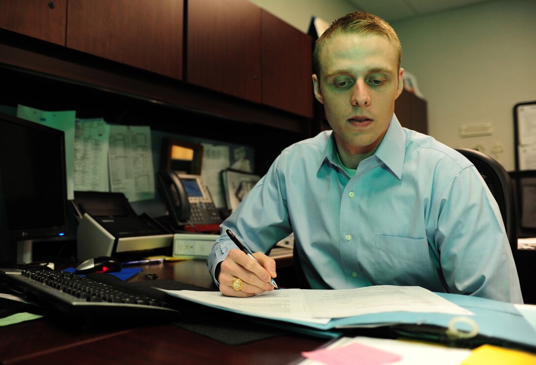 Mathew Engelbaum, 633rd Air Base Wing Legal Office intern, reviews private organizations’ programs at Langley Air Force Base, Va., Dec. 12, 2014. Englebaum is a participant of the U.S. Air Force’s legal internship program hosted at Langley AFB three times a year.(U.S. Air Force photo by Airman 1st Class Areca T. Wilson/Released) 
