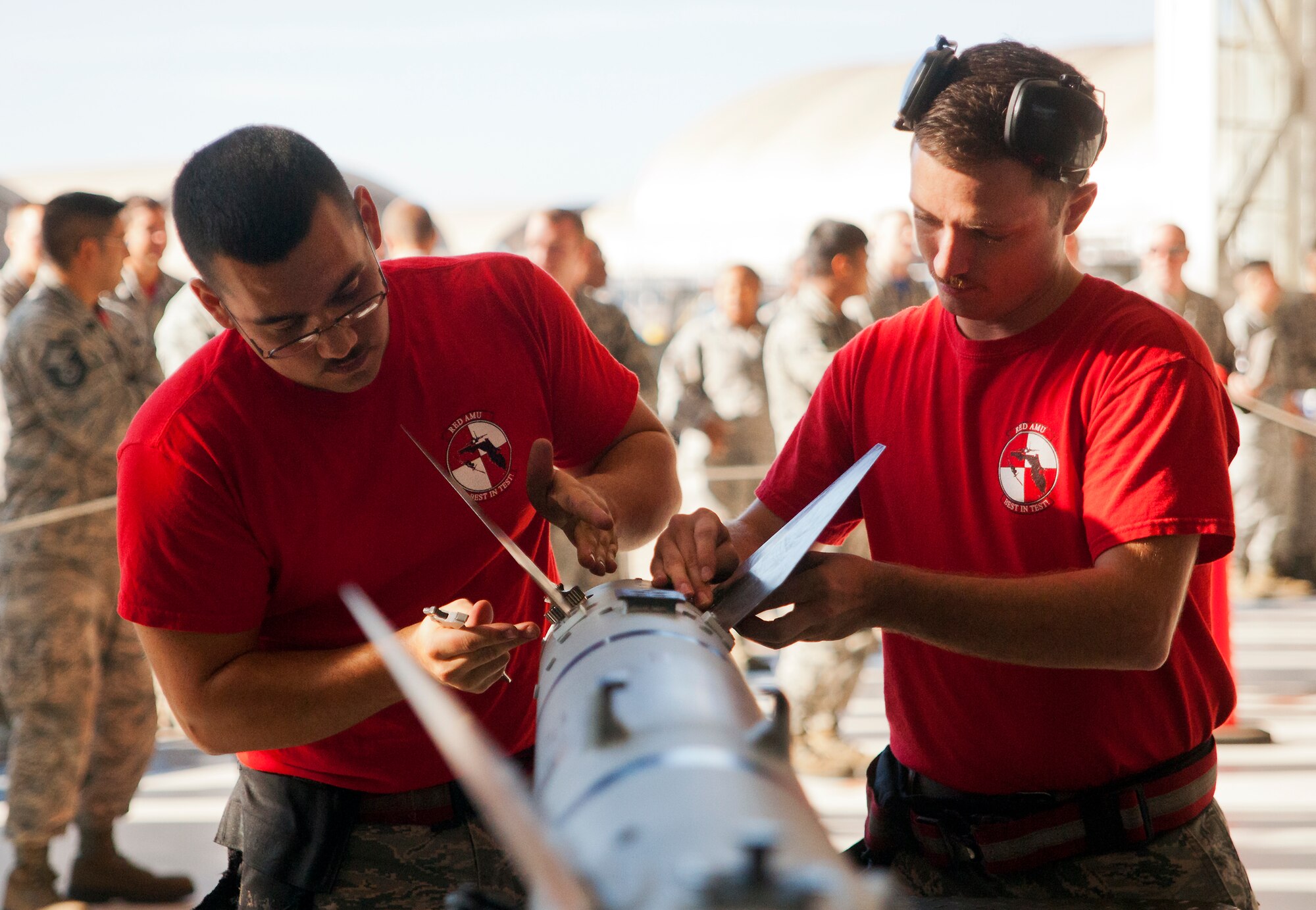 Senior Airman Christopher Mann and Staff Sgt. Stephen Presley, from 96th Aircraft Maintenance Squadron Red, secure the fins onto an AIM-120 during the 96th Maintenance Group’s quarterly weapons load crew competition Dec. 5 at Eglin Air Force Base, Fla.  The Red F-15 team won out over the 96th Aircraft Maintenance Squadron’s Blue F-16 team.  (U.S. Air Force photo/Samuel King Jr.)