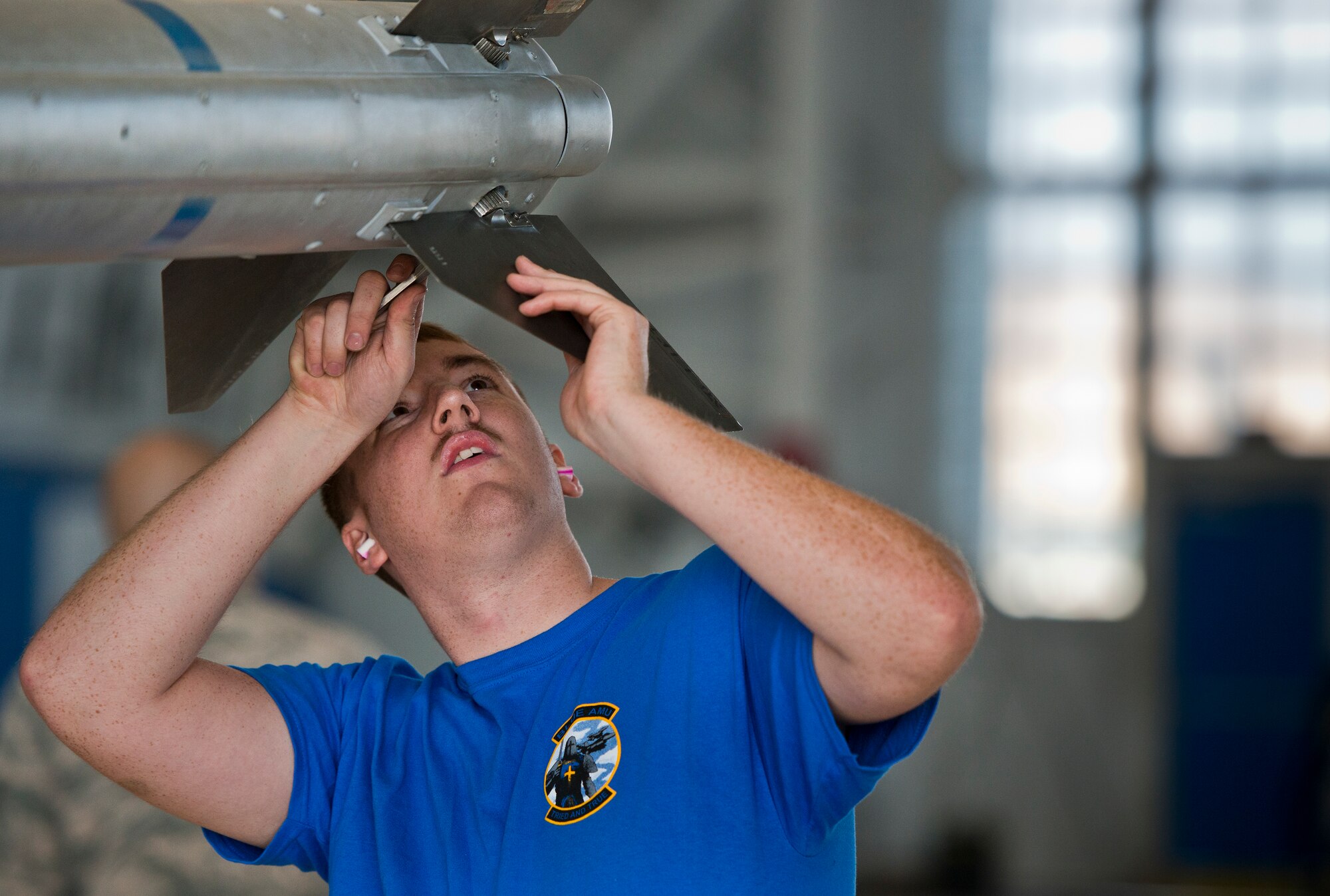 Senior Airman Bart Koch, from the 96th Aircraft Maintenance Squadron Blue, secures the fins onto an AIM-120 during the 96th Maintenance Group’s quarterly weapons load crew competition Dec. 5 at Eglin Air Force Base, Fla.  The Blue crew battled the 96th Aircraft Maintenance Squadron’s Red F-15 crew for quickest and most accurate load of an AIM-9X and an AIM-120 on their respective aircraft.  (U.S. Air Force photo/Samuel King Jr.)