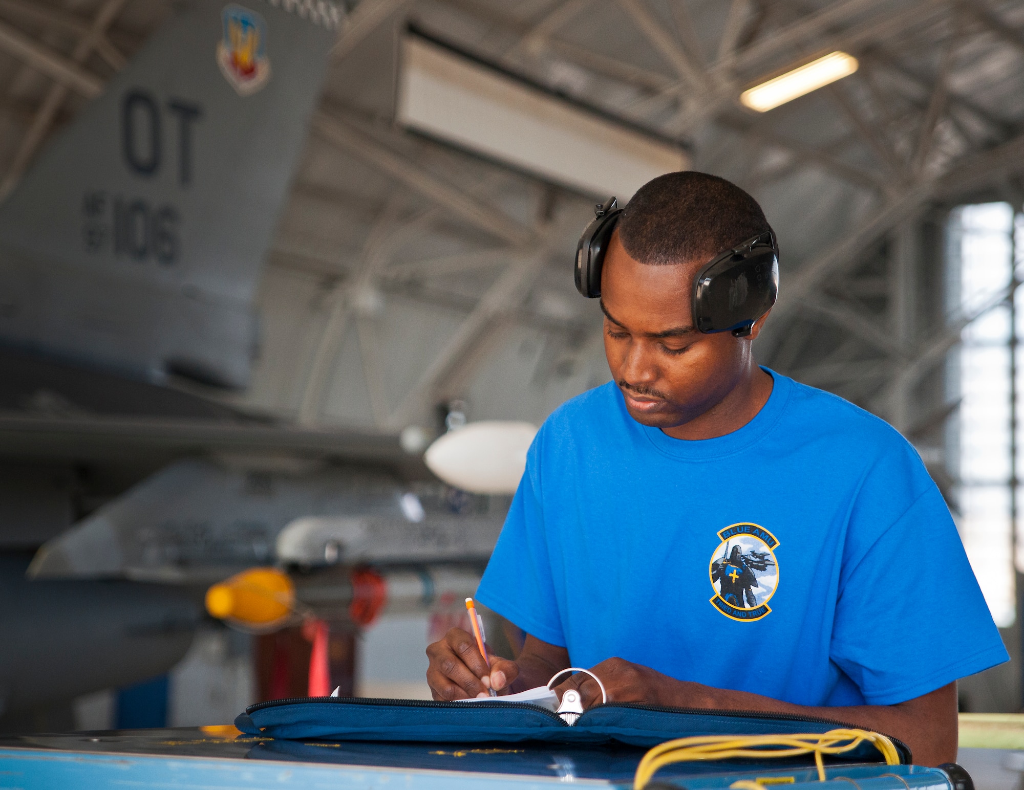 Staff Sgt. Adrian Baker, 96th Aircraft Maintenance Squadron Blue, writes in the F-16 Fighting Falcon’s log book during the 96th Maintenance Group’s quarterly weapons load crew competition Dec. 5 at Eglin Air Force Base, Fla.  The Blue crew battled the 96th Aircraft Maintenance Squadron’s Red F-15 crew for quickest and most accurate load of an AIM-9X and an AIM-120 on their respective aircraft.  (U.S. Air Force photo/Samuel King Jr.)