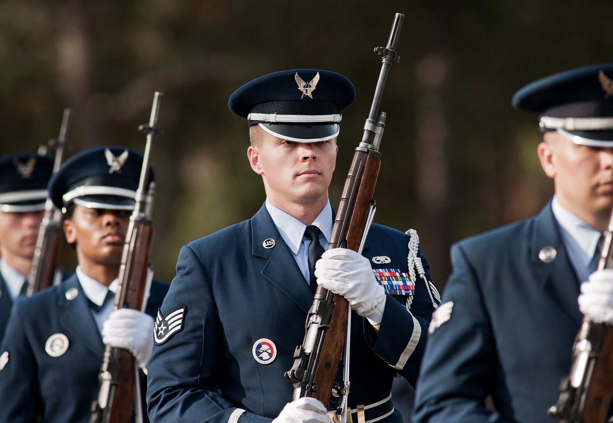 Staff Sgt. Sean Edmondson and other new honor guard members exit the field after the funeral ceremony at the honor guard graduation Dec. 3 at Eglin Air Force Base, Fla.  Approximately 12 new Airmen graduated from the 80-plus-hour course. The graduation performance is a full military honors funeral to include flag detail, rifle volley, pall bearers and bugler.  (U.S. Air Force photo/Samuel King Jr.)