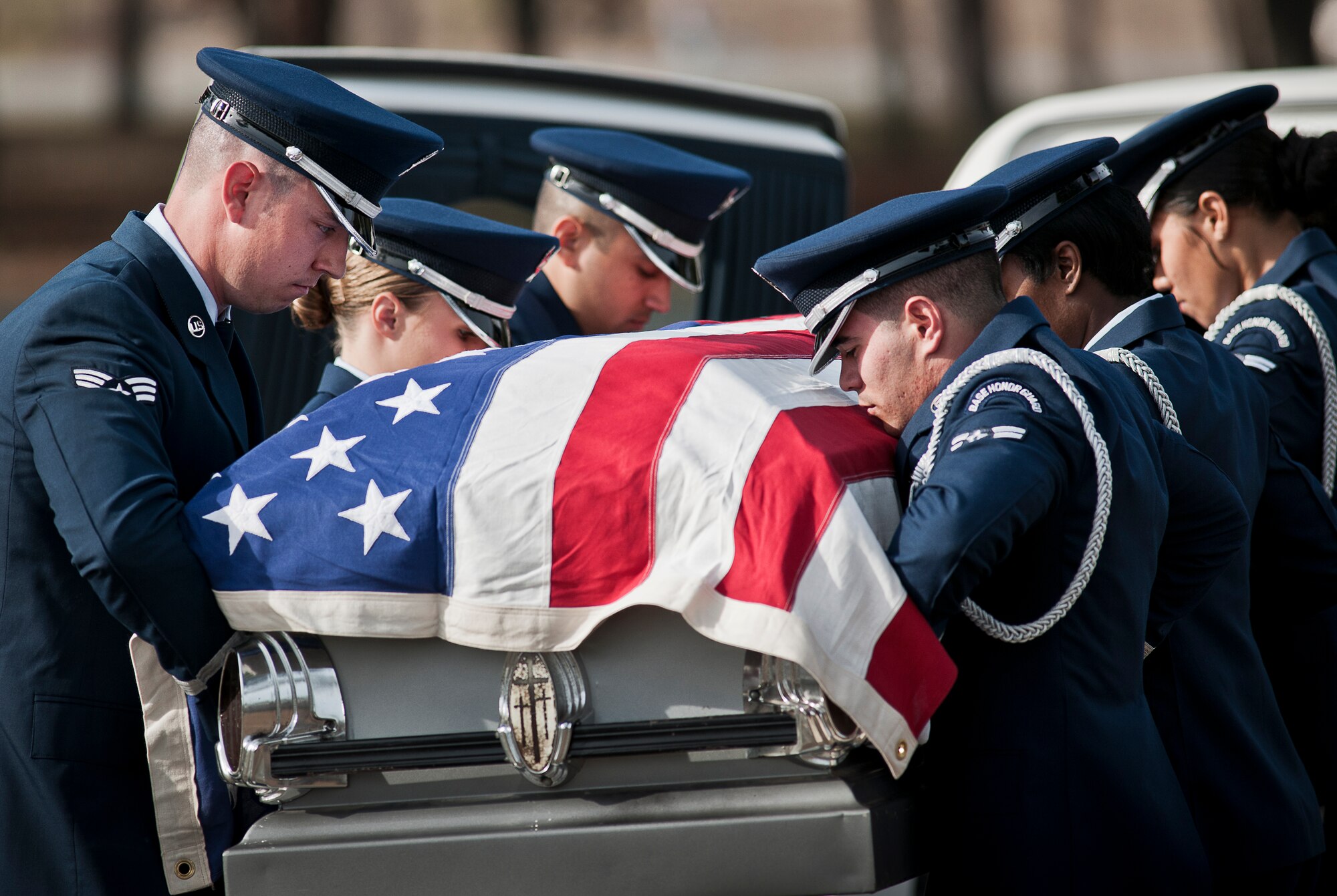 New honor guard members remove the casket from the hearse during the funeral ceremony at the honor guard graduation Dec. 3 at Eglin Air Force Base, Fla.  Approximately 12 new Airmen graduated from the 80-plus-hour course. The graduation performance is a full military honors funeral to include flag detail, rifle volley, pall bearers and bugler.  (U.S. Air Force photo/Samuel King Jr.)