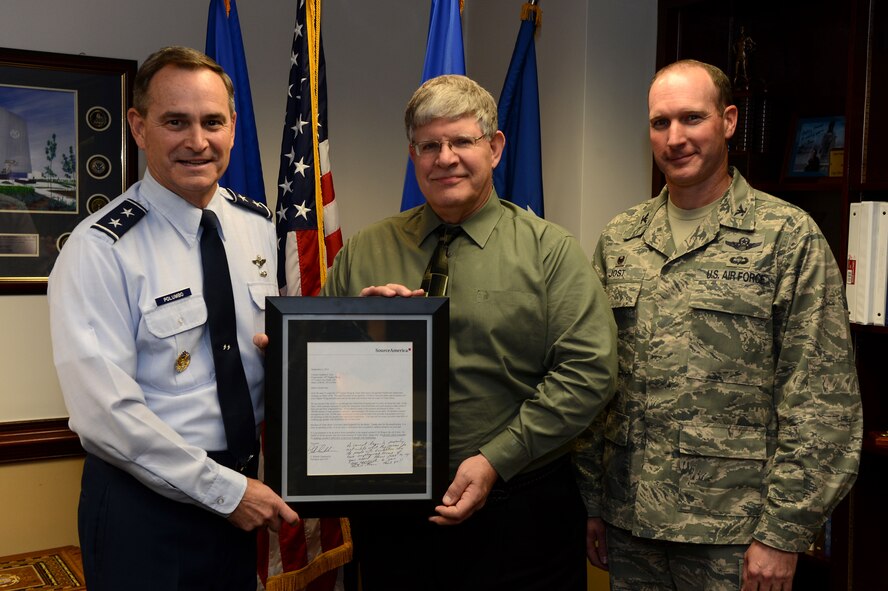 (From right) U.S. Air Force Col. Stephen Jost, 20th Fighter Wing commander, and Randy May, 20th Contracting Squadron director of business operations, are presented with a letter of recognition for their involvement with the AbilityOne Program by Maj. Gen. H.D. Polumbo Jr., Ninth Air Force commander, at Shaw Air Force Base, S.C., Dec. 8, 2014. Since 1996, the 20th FW has partnered with the AbilityOne Program, a federal program that provides employment opportunities to blind or disabled Americans. Approximately 75 AbilityOne workers are employed by the 20th FW and work throughout the base. (U.S. Air Force photo by Airman 1st Class Jensen Stidham/Released)
