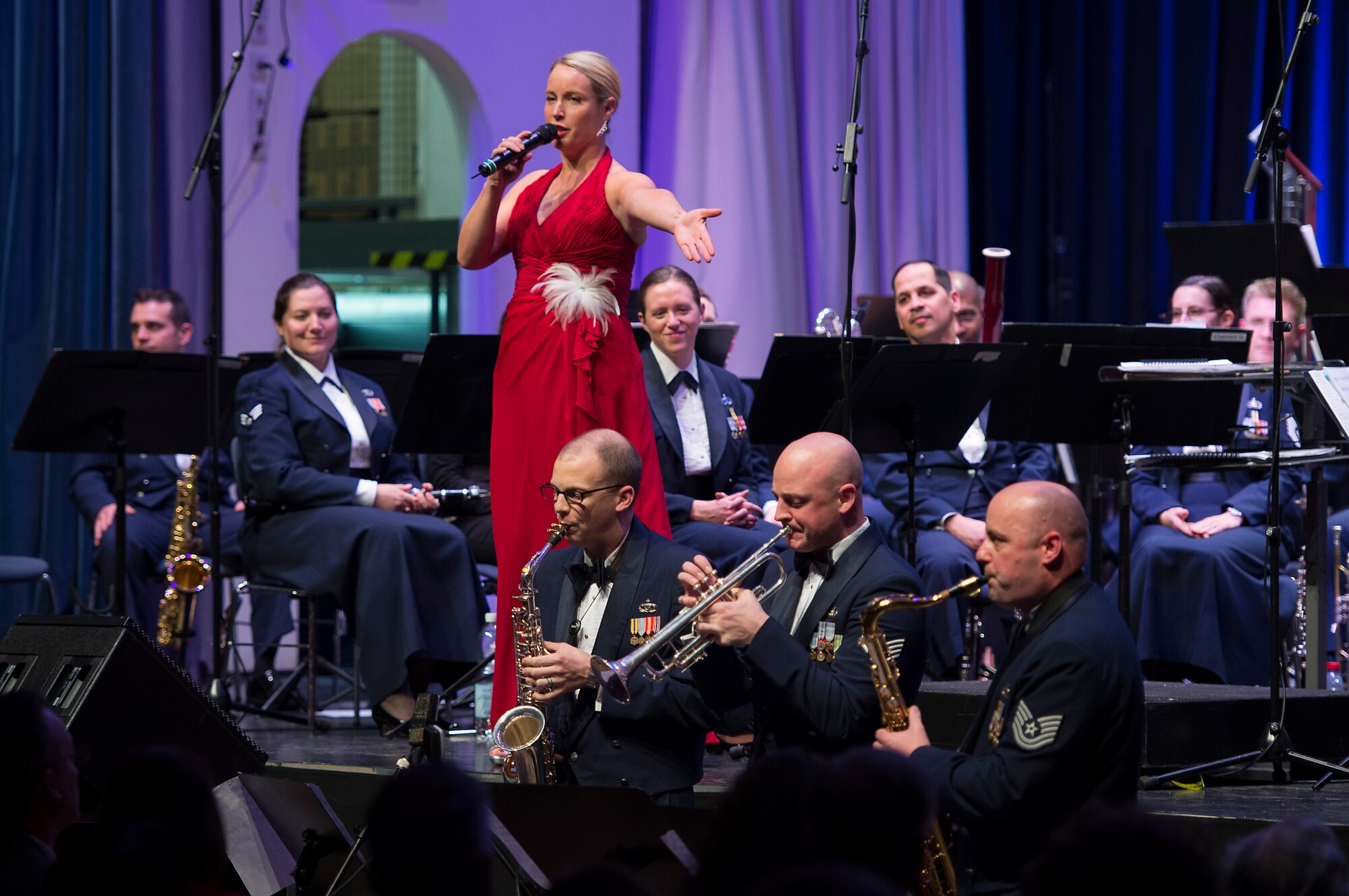 Staff Sgt. Jill Diem, U.S. Air Forces in Europe vocalist, sings during the annual KMC Christmas Concert, at the Fruchthalle, Kaiserslautern, Germany, Dec. 12, 2014. The USAFE Band performs in hundreds of concerts throughout Europe and Africa every year, supporting the global Air Force mission and increase Airmen morale. (U.S. Air Force photo/Senior Airman Damon Kasberg)