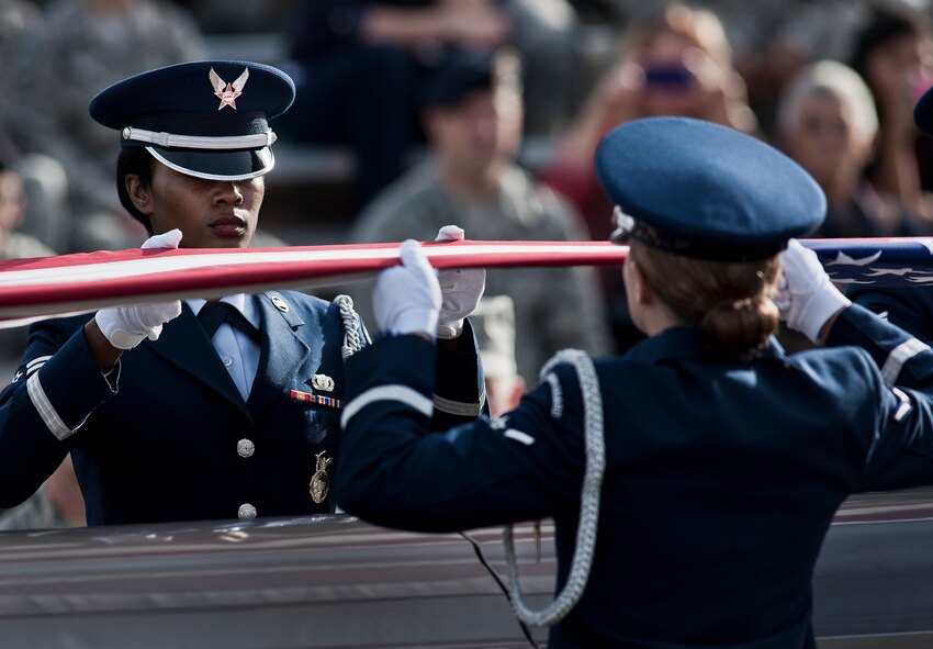 Airman 1st Class Shamonica Jones holds a fold of the American flag during the funeral ceremony at the honor guard graduation Dec. 3 at Eglin Air Force Base, Fla.  Approximately 12 new Airmen graduated from the 80-plus-hour course. The graduation performance is a full military honors funeral to include flag detail, rifle volley, pall bearers and bugler.  (U.S. Air Force photo/Samuel King Jr.)