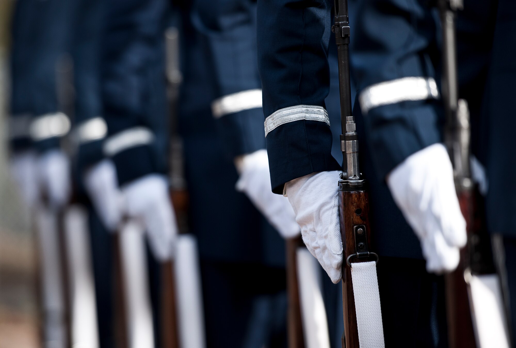New honor guard members stand with their rifles prior to their graduation performance of a full military honors funeral Dec. 3 at Eglin Air Force Base, Fla.  Approximately 12 new Airmen graduated from the 80-plus-hour course. The graduation performance includes flag detail, rifle volley, pall bearers and bugler for friends, family and unit commanders.  (U.S. Air Force photo/Samuel King Jr.)