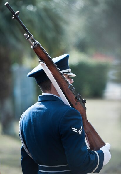 Senior Airman Ramero Esparza holds his rifle as part of the flag detail team for the funeral ceremony at the honor guard graduation Dec. 3 at Eglin Air Force Base, Fla.  Approximately 12 new Airmen graduated from the 80-plus-hour course. The graduation performance is a full military honors funeral to include flag detail, rifle volley, pall bearers and bugler.  (U.S. Air Force photo/Samuel King Jr.)