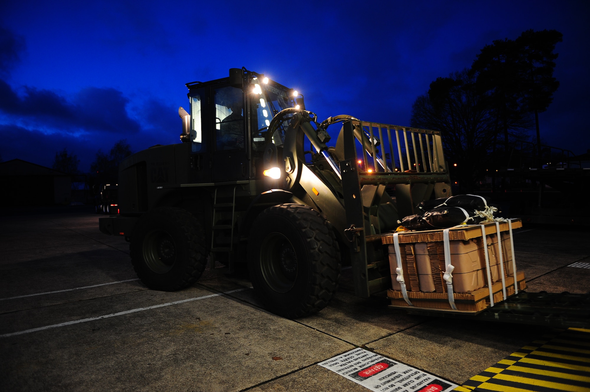 Staff Sgt. Brantley Roberson, 86th Logistics Readiness Squadron aerial delivery technician, prepares to move a container specifically built for Santa Claus to deliver toys to children Dec. 15, 2014, Ramstein Air Base, Germany. After being loaded, the bundles will be air dropped at U.S. Army Garrison Baumholder along with Santa so that he can deliver them to local families in need of a little support this holiday season. (U.S. Air Force photo/Staff Sgt. Kris Levasseur)