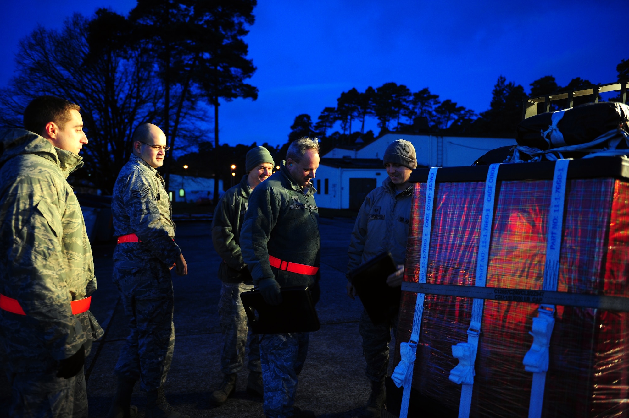 Members of the aerial delivery team, aka. Santa’s elves, inspect a bundle of toys to ensure it is safe for Santa to drop out of the back of a C-130J Super Hercules on Dec. 15, 2014, Ramstein Air Base, Germany. The aerial delivery team, along with members of various organizations from around the European theater, spent countless hours gathering and preparing donations to be delivered to children in need. (U.S. Air Force photo/Staff Sgt. Kris Levasseur)