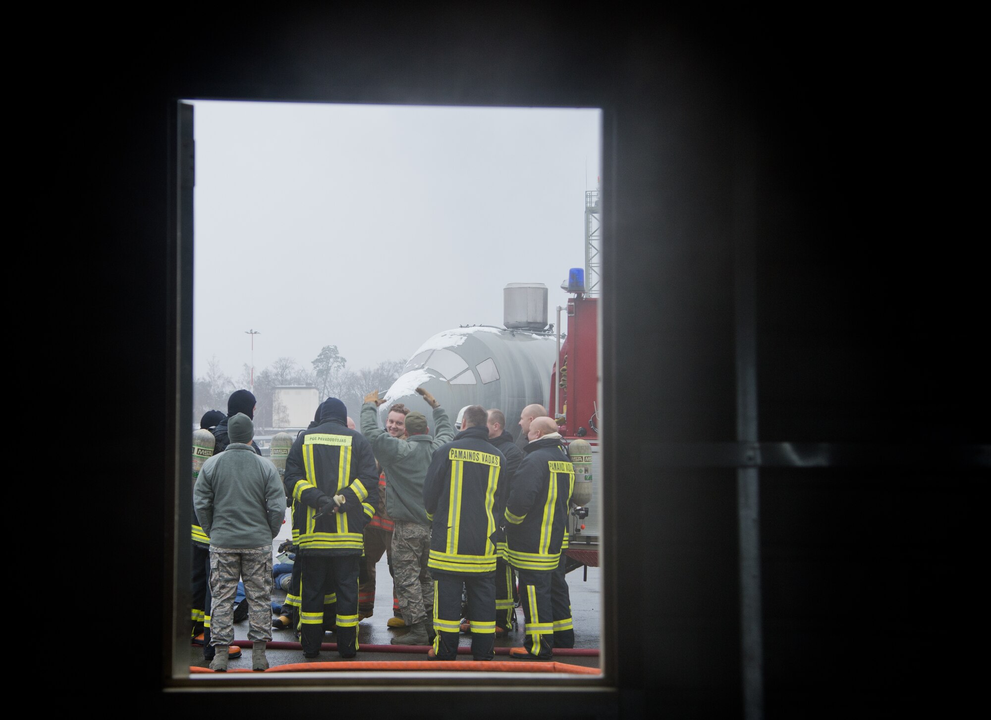 Airmen from the 435th Air Ground Operations Wing’s Contingency Response Group talk to their Lithuanian counterparts about the search and rescue demonstration as well as other lifesaving skills that can be used in the field Dec. 4, 2014, at Ramstein Air Base, Germany. Airmen from the 435th CRG familiarized 12 Lithuanian Airmen on various firefighting procedures they use and so the two countries can work together better any contingency operation missions. (U.S. Air Force photo/Senior Airman Jonathan Stefanko)