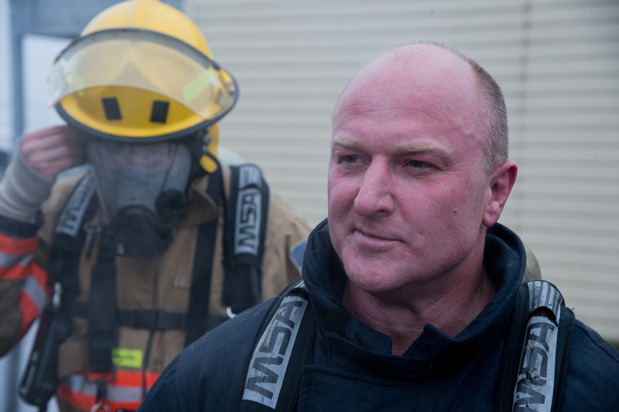Lithuanian air force firefighters remove their gear after participating in a search and rescue demonstration Dec. 4, 2014, at Ramstein Air Base, Germany. Airmen from the 435th Air Ground Operations Wing’s Contingency Response Group familiarized 12 Lithuanian Airmen on various firefighting procedures they use and so the two countries can work together better any contingency operation missions. (U.S. Air Force photo/Senior Airman Jonathan Stefanko)