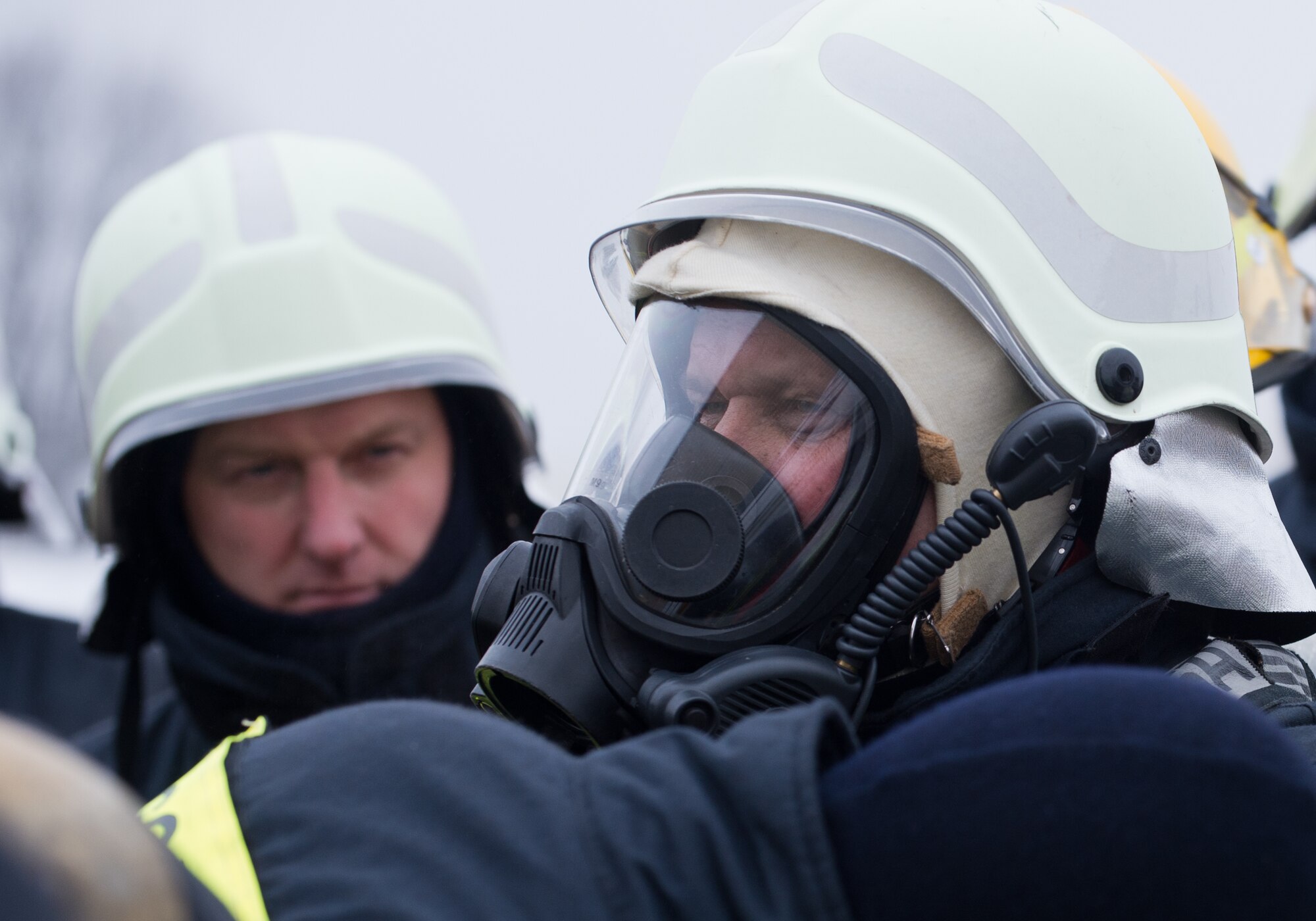 A Lithuanian air force firefighter dawns a mask before undergoing a search and rescue demonstration Dec. 4, 2014, at Ramstein Air Base, Germany. Airmen from the 435th Air Ground Operations Wing’s Contingency Response Group familiarized 12 Lithuanian Airmen on various firefighting procedures they use and so the two countries can work together better any contingency operation missions. (U.S. Air Force photo/Senior Airman Jonathan Stefanko)