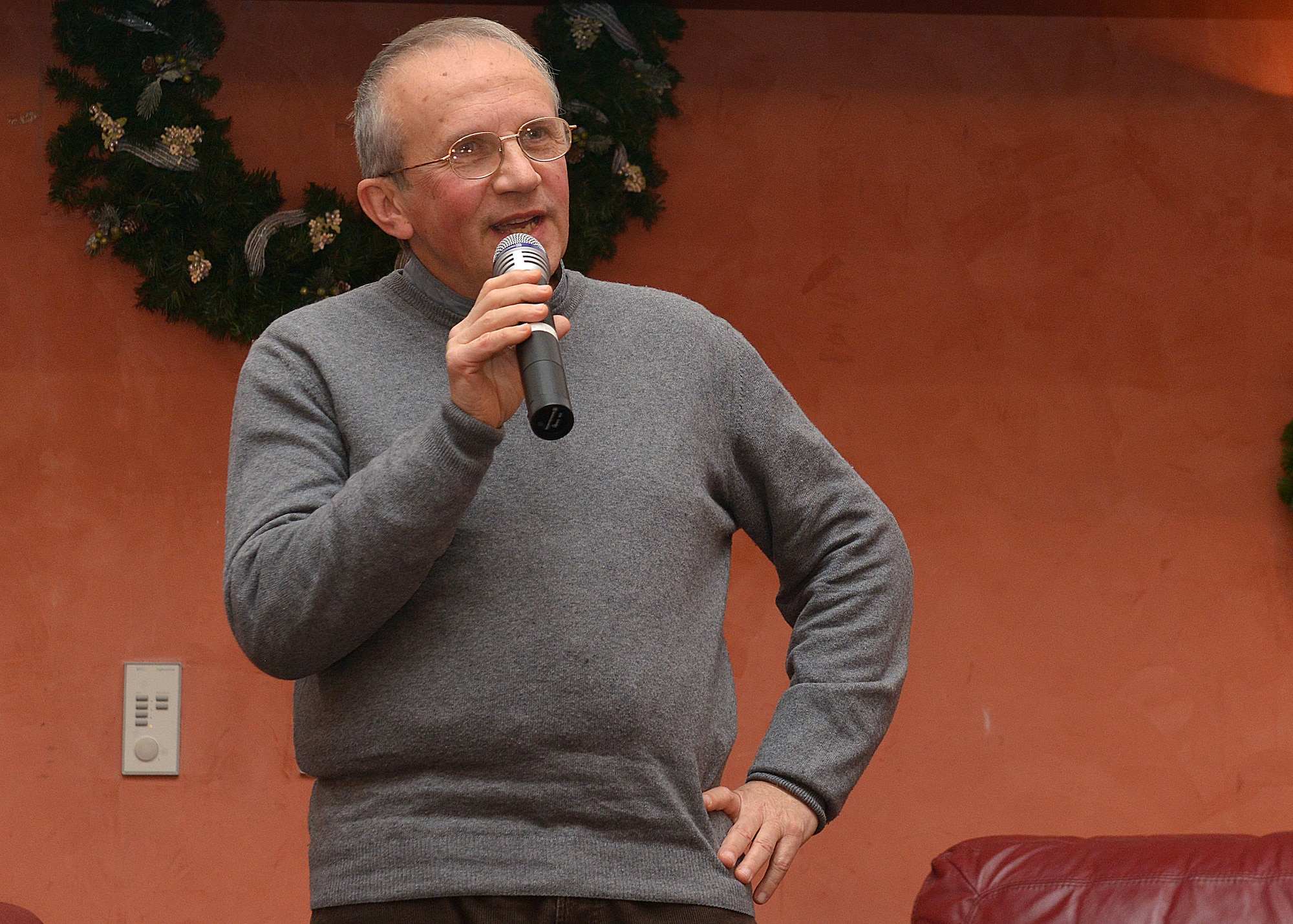 Father Giuseppe Pierantoni, an Italian priest, shares his story during the 3rd annual Storytellers event, Dec. 12, 2014, at Aviano Air Base, Italy. Pierantoni was kidnapped on a mission trip to the Philippines in 2001 and shared his story of adversity and resilience with Team Aviano members. (U.S. Air Force photo/Airman 1st Class Ryan Conroy) 