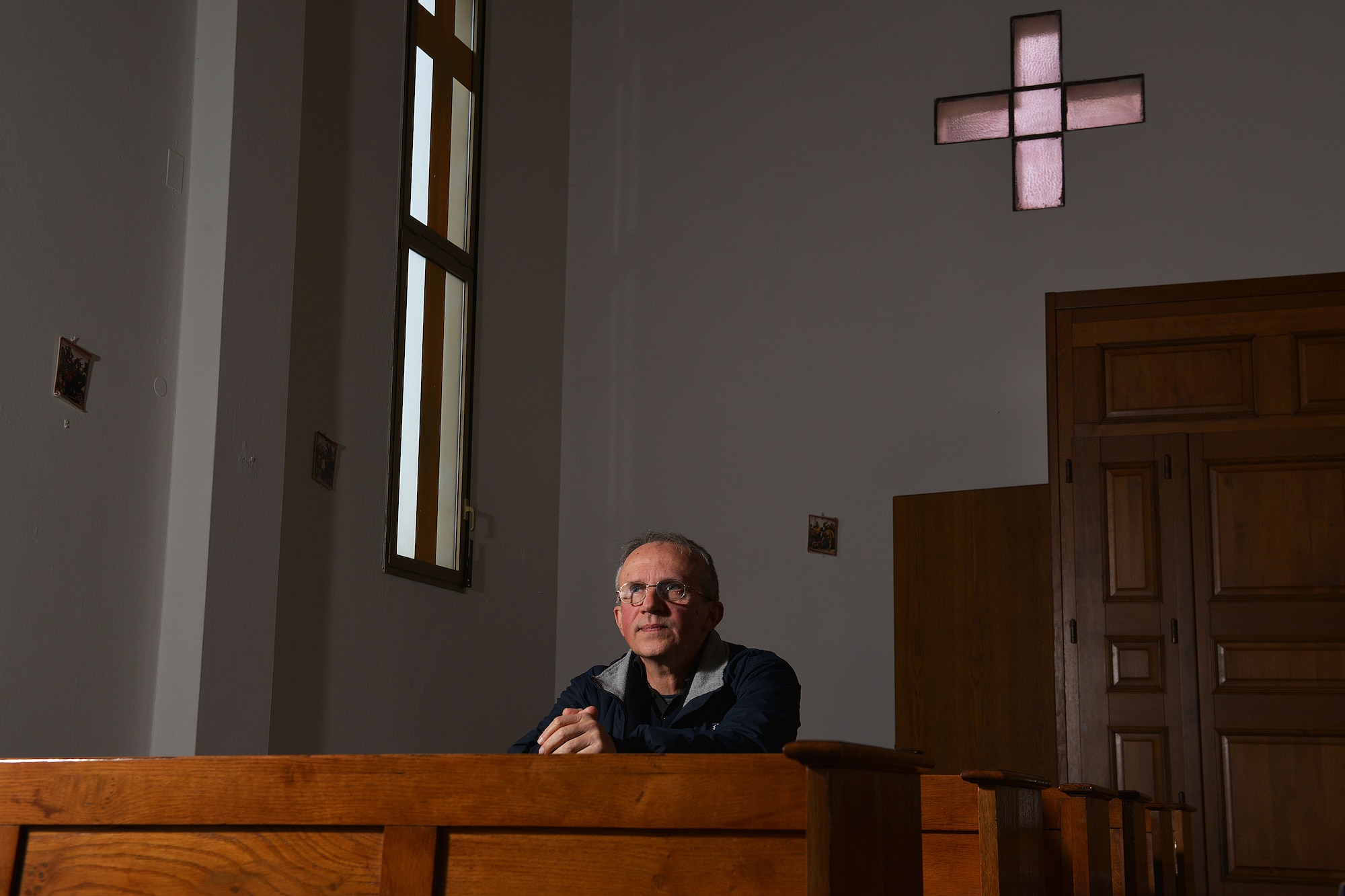Father Giuseppe Pierantoni, an Italian priest, sits in pews at the base chapel, Dec. 2, 2014, at Aviano Air Base, Italy. Pierantoni was kidnapped on a mission trip to the Philippines in 2001 and shared his story of adversity and resilience with Team Aviano members during the 3rd annual Storytellers event. (U.S. Air Force photo/Airman 1st Class Ryan Conroy)