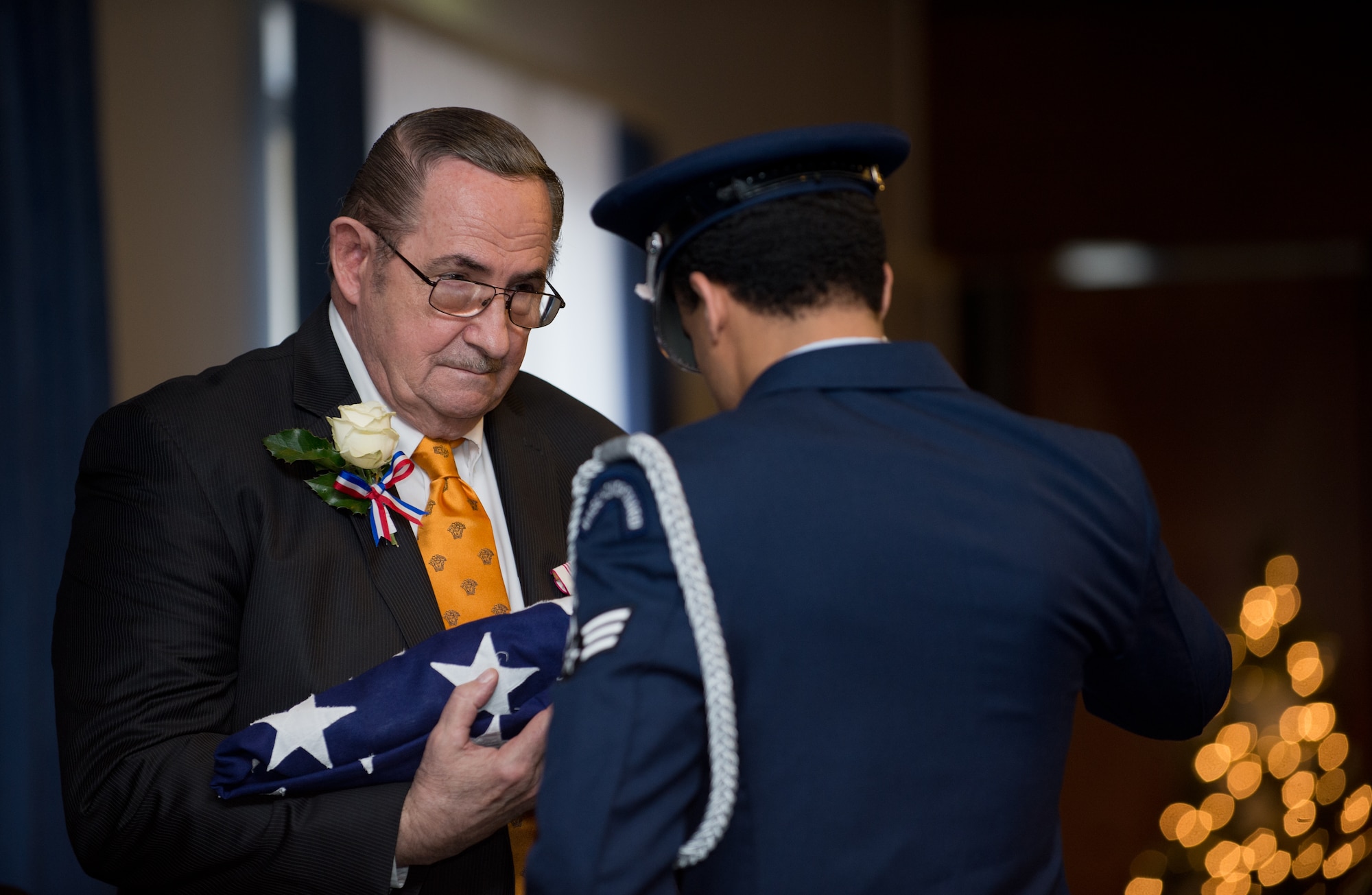 John Mace receives an American flag during his retirement Dec. 12, 2014, at Ramstein Air Base, Germany. Mace retired from the military after 25 years and retired again from civil service after 29 years. Mace was the special operations medical officer for the 86th Medical Group, where he provided comprehensive medical care to the 86th Airlift Wing, U.S. Air Forces in Europe, joint service partners and numerous embassies and consulates throughout Europe, Africa and the Middle East. (U.S. Air Force photo/Senior Airman Jonathan Stefanko)