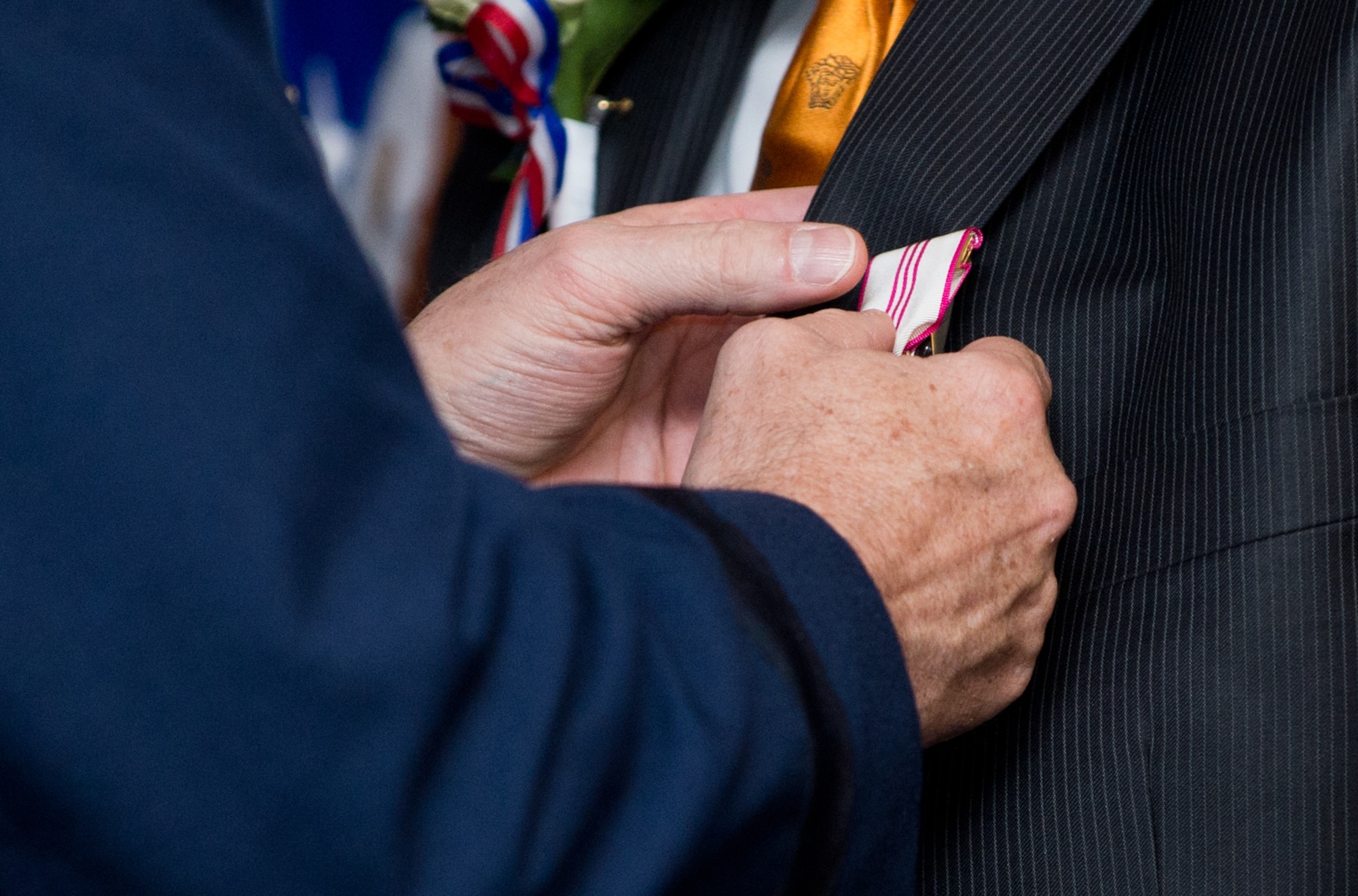 Gen. Philip M. Breedlove, commander of U.S. European Command and Supreme Allied Commander Europe, pins the Outstanding Civilian Career Service Award onto John Mace during his retirement ceremony Dec. 12, 2014, at Ramstein Air Base, Germany. Mace retired from the military after 25 years and retired again from civil service after 29 years. Mace was the special operations medical officer for the 86th Medical Group, where he provided comprehensive medical care to the 86th Airlift Wing, U.S. Air Forces in Europe, joint service partners and numerous embassies and consulates throughout Europe, Africa and the Middle East. (U.S. Air Force photo/Senior Airman Jonathan Stefanko)