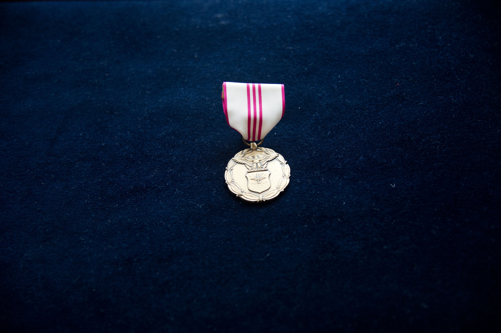 The Outstanding Civilian Career Service Award waits to be pinned onto John Mace during his retirement, Dec. 12, 2014, at Ramstein Air Base, Germany. Mace retired from the military after 25 years and retired again from civil service after 29 years. Mace was the special operations medical officer for the 86th Medical Group, where he provided comprehensive medical care to the 86th Airlift Wing, U.S. Air Forces in Europe, joint service partners and numerous embassies and consulates throughout Europe, Africa and the Middle East. (U.S. Air Force photo/Senior Airman Jonathan Stefanko)