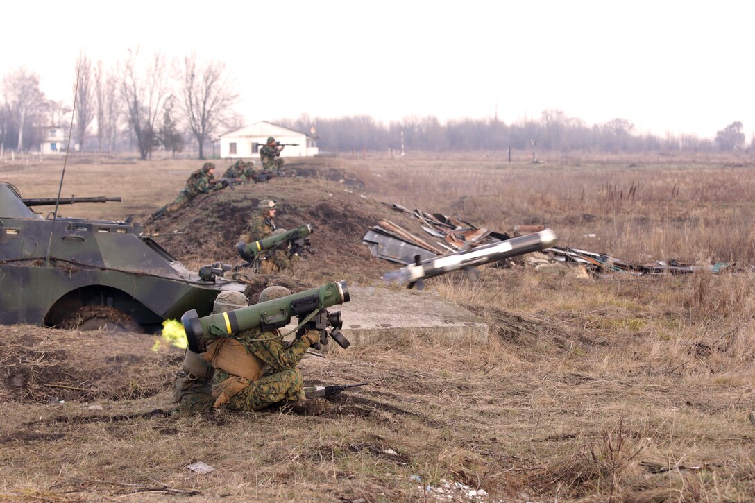 An FGM-148 Javelin man-portable anti-tank missile is fired during the coordinated simulated assault at the anti-armor workshop in Balti, Moldova, Dec. 12, 2014. The anti-armor attack integrated U.S. Marines with Moldovan soldiers with various weapons.