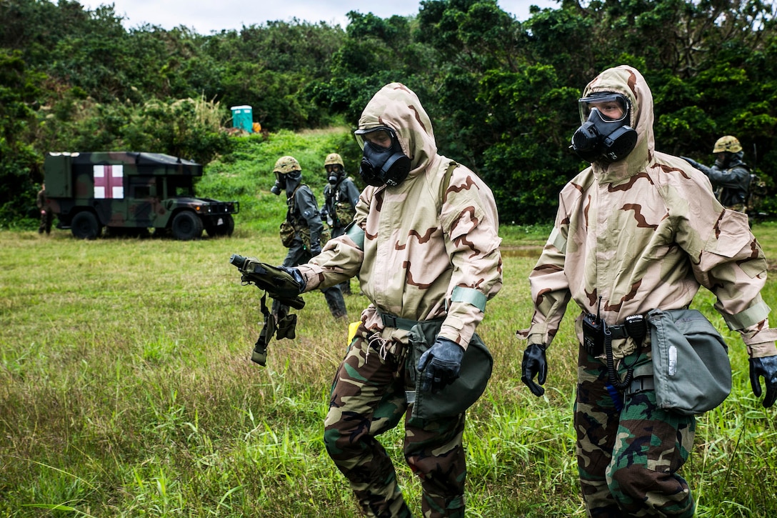 Japan Ground Self-Defense Force members and U.S. Marines prepare and plan reconnaissance of a simulated contamination zone with casualties Dec. 1 at Camp Naha, Okinawa. The demonstration consisted of reconnaissance, casulty packaging and extraction, victim care, and immediate decontamination. The Marines are chemical, biological, radiological and nuclear defense specialists with CBRN Unit, Headquarters Regminet, 3rd Marine Logistics Group, III Marine Expeditionary Force. The JGSDF members are with the Nuclear Biological Chemical Unit, 15th Brigade.