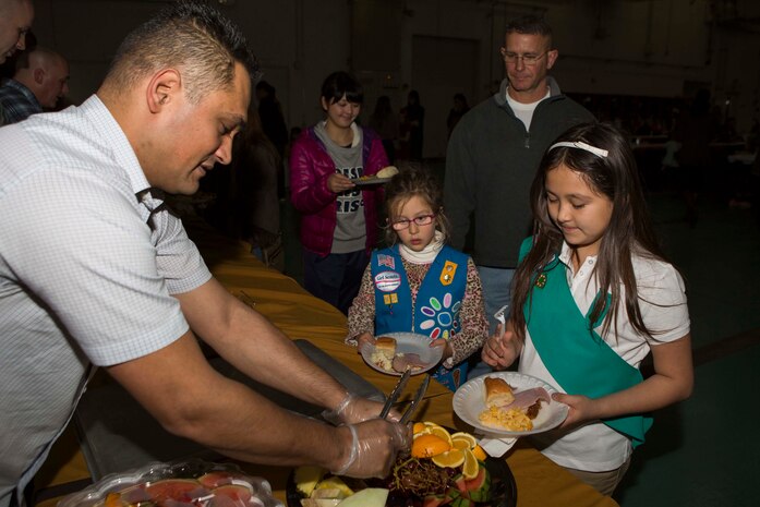Gunnery Sgt. Nathan Lanham, the embarkation chief with Aircraft Rescue Firefighting, passes out fruit to guest of ARFF’s annual holiday party, Dec. 12, 2014, inside the ARFF compound aboard Marine Corps Air Station Iwakuni, Japan. The holiday party was hosted as part of an existing relationship between ARFF and the Tsuta Children’s Home, where members of ARFF invite the children’s home aboard station to spread holiday cheer.

