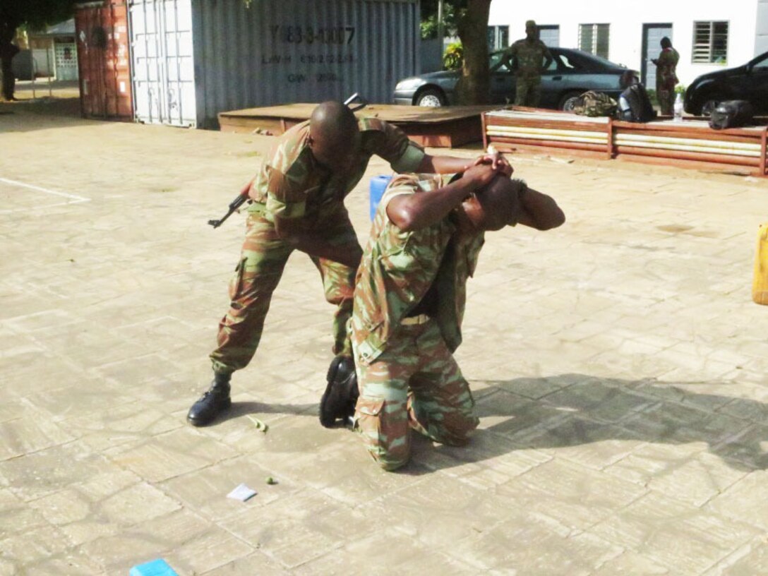 A sailor with the Beninese Navy conducts a personnel search during a theater security cooperation engagement with U.S. Marines in Contonou, Benin, Nov. 27, 2014. Training focused on weapons safety and handling, rules of engagement, escalation of force, personnel and vehicles searches, vehicle entry points as well as entry control points — ending with a final exercise that tested the collective tactical knowledge learned over the course of the training engagement. Marines with SPMAGTF Crisis Response-Africa conducted the TSC engagement to help develop and enhance armed sentry skills as the Beninese Navy is preparing to deploy on a peace-keeping mission to the Democratic Republic of Congo (DRC) where they will be standing sentry duties. (Courtesy Photo)