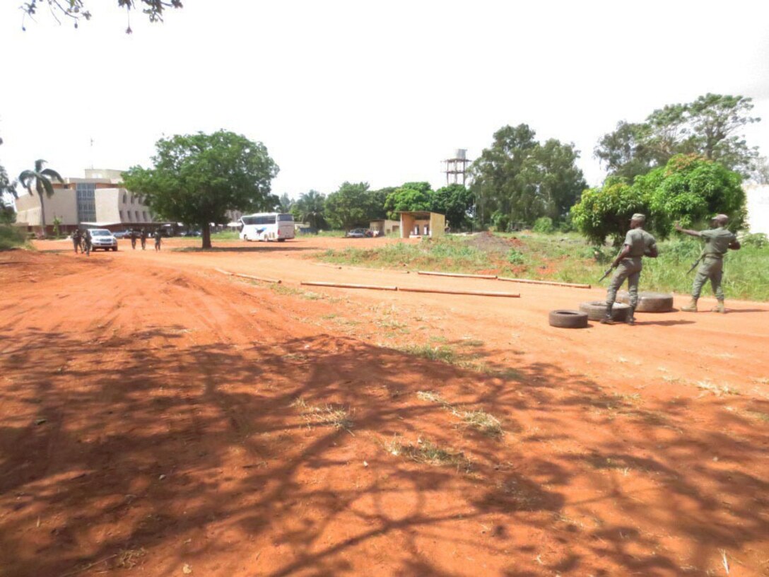 Service members with the Togolese Armed Forces give a warning signal to a vehicle entering their ‘Entry Control Point’ as part of a theater security cooperation engagement with U. S. Marines in Lome, Togo, Dec. 4, 2014. In Togo, the Marines trained alongside 20 students from the Togoloese Army, Air Force, Navy and the Gendarmerie forces. Training in both regions focused on weapons safety and handling, rules of engagement, escalation of force, personnel and vehicle searches, vehicle entry points as well as entry control points—ending with a final exercise that tested the collective tactical knowledge learned over the course of the training engagement. Marines with SPMAGTF Crisis Response-Africa conducted the TSC engagement to help develop and enhance armed sentry skills sharing tactics, techniques and procedures with the Togolese Armed Forces. (Courtesy Photo)