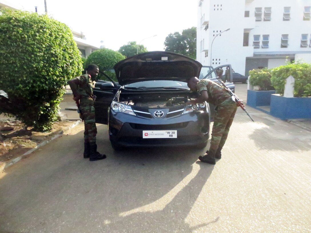 Sailors with the Beninese Navy conduct a vehicle search during a theater security cooperation engagement with U.S. Marines in Contonou, Benin, Nov. 26, 2014. Training in both regions focused on weapons safety and handling, rules of engagement, escalation of force, personnel and vehicle searches, vehicle entry points as well as entry control points—ending with a final exercise that tested the collective tactical knowledge learned over the course of the training engagement. Marines with SPMAGTF Crisis Response-Africa conducted the TSC engagement to help develop and enhance armed sentry skills as the Beninese Navy is preparing to deploy on a peace-keeping mission to the Democratic Republic of Congo (DRC) where they will be standing sentry duties. (Courtesy Photo)