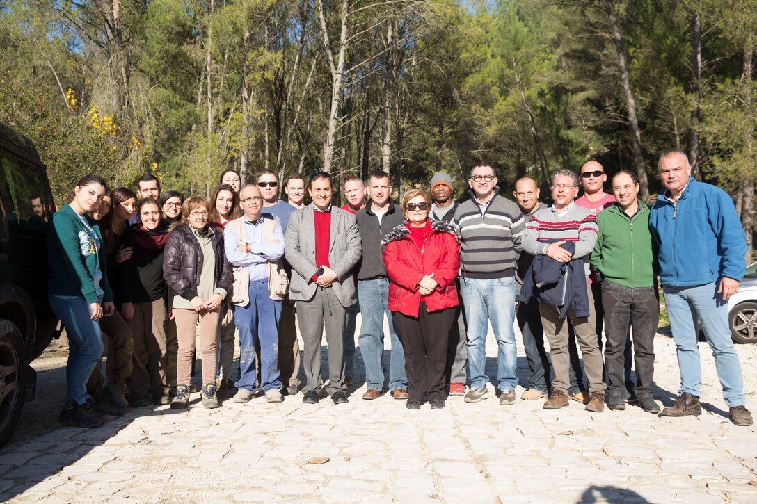 Marines with SPMAGTF Crisis Response-Africa pose for a photo with Sicilian locals at Parco Forestale Di Calaforno (Park Forestry of Calaforno), an ancient burial site in Ragusa, Sicily, Dec. 12, 2014 After a request from the lead archeologist to the Naval Air Station Sigonella Community Relations office, 20 Marines and Sailors with SPMAGTF-CR-AF helped excavate cave openings to burial chambers potentially dating back thousands of years, potentially to 2200 BC. (U.S. Marine Corps Photo by Cpl. Shawn Valosin)