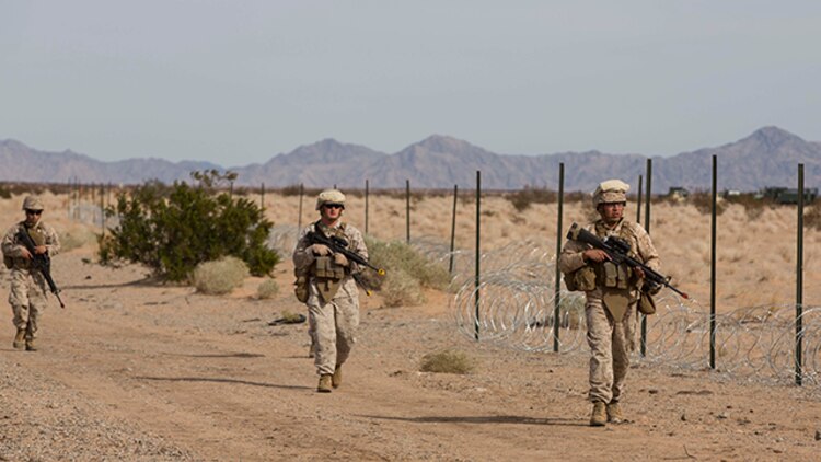 Marines with Marine Wing Support Squadron 371 complete a foot patrol during the security force exercise in support of pre-deployment training Dec. 7-10, 2014, at the Auxiliary Landing Field II on Marine Corps Air Station Yuma, Ariz. (U.S. Marine Corps photo by Cpl. Reba James/ Released)