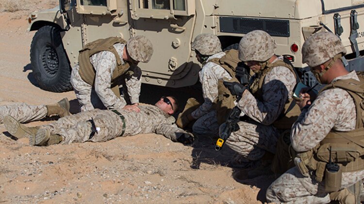 Marines with Marine Wing Support Squadron 371 perform casualty care while on patrol during the security force exercise in support of pre-deployment training Dec. 7-10, 2014, at the Auxiliary Landing Field II on Marine Corps Air Station Yuma, Ariz. As a part of the exercise, Marines called in a 9-line casualty evacuation as if they were deployed, in order to get the casualty to safety. (U.S. Marine Corps photo by Cpl. Reba James/ Released)