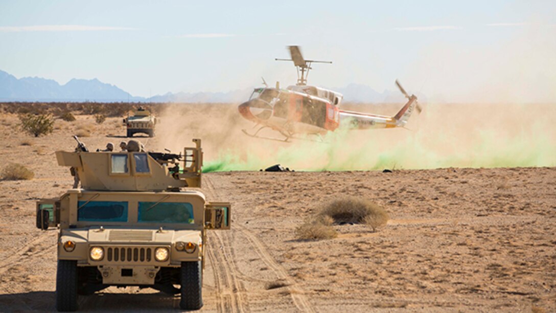 A Marine search and rescue team with Marine Corps Air Station Yuma, Ariz., arrives at the landing zone for a casualty evacuation in support of Marine Wing Support Squadron 371 during the security force exercise in support of pre-deployment training Dec. 7-10, 2014, at the Auxiliary Landing Field II on station. The Search and Rescue team provided support during a practical application of casualty evacuation. (U.S. Marine Corps photo by Cpl. Reba James/ Released)