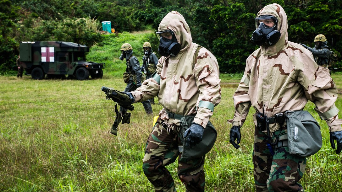 Japan Ground Self-Defense Force members and U.S. Marines prepare and plan reconnaissance of a simulated contamination zone with casualties Dec. 1 at Camp Naha, Okinawa. The demonstration consisted of reconnaissance, casualty packaging and extraction, victim care, and immediate decontamination. The Marines are chemical, biological, radiological and nuclear defense specialists with CBRN Unit, Headquarters Regiment, 3rd Marine Logistics Group, III Marine Expeditionary Force. The JGSDF members are with the Nuclear Biological Chemical Unit, 15th Brigade. 
