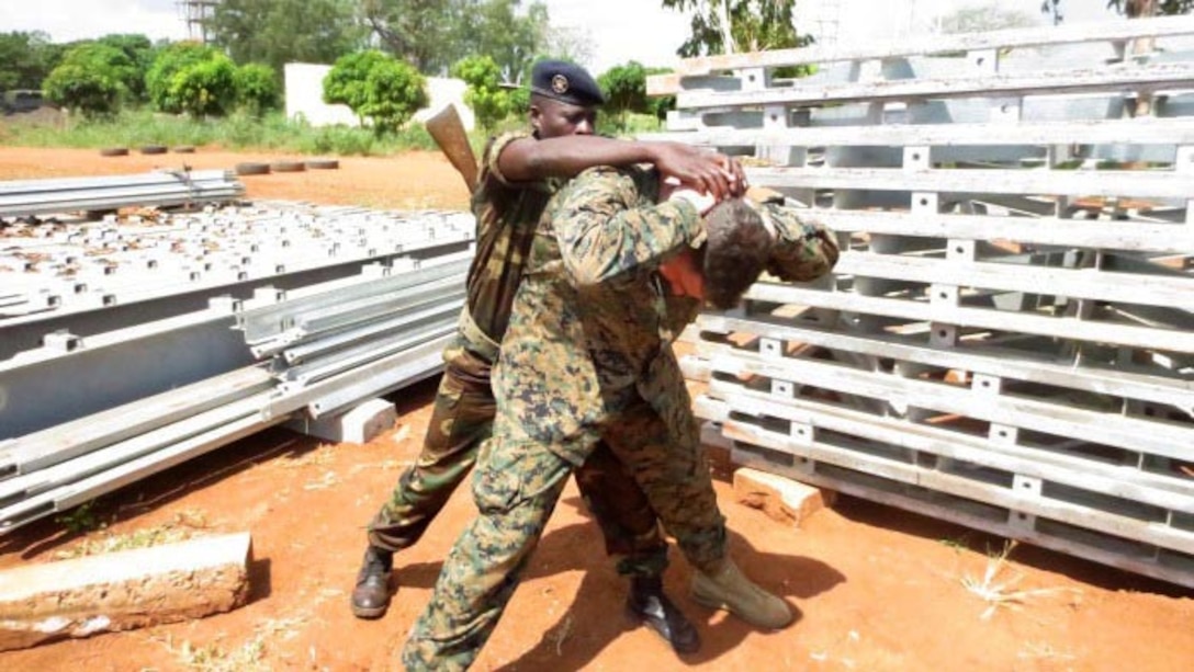 A service member with the Togolese Armed Forces conducts a personnel search on 1st Lt. Kyle Faherty during a armed sentry training engagement with U.S. Marines in Lome, Togo, Dec. 4, 2014. In Togo, the Marines trained alongside 20 students from the Togoloese Army, Air Force, Navy and the Gendarmerie forces. Training in both regions focused on weapons safety and handling, rules of engagement, escalation of force, personnel and vehicle searches, vehicle entry points as well as entry control points—ending with a final exercise that tested the collective tactical knowledge learned over the course of the training engagement. Marines with SPMAGTF Crisis Response-Africa conducted the theater security cooperation engagement to help develop and enhance armed sentry skills sharing tactics, techniques and procedures with the Togolese Armed Forces. 