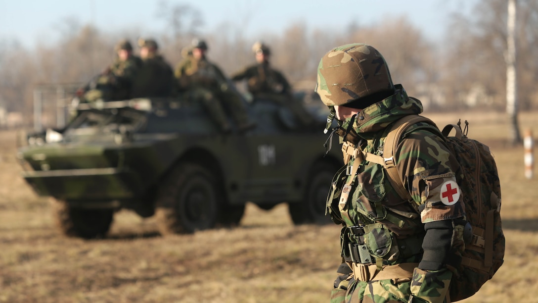 A Moldovan medic stands watch as the final simulated assault is conducted during an Anti-Armor Workshop in Balti, Moldova, Dec. 12. The Marines and Moldovans built a mutual understanding of firing procedures and characteristics on advanced anti-armor weapons systems, including: Moldova’s Rocket Propelled Grenade system and 70mm Recoiless Rifle (SPG), and America’s FGM-148 Javelin man-portable anti-tank missile, AT-4 Anti-Tank Weapon, and the Shoulder-launched Multipupose Assault Weapon, Dec. 8-12.