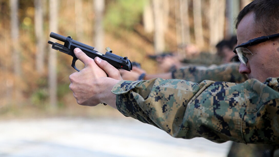 Marines paticipating in the EOTG Urban Sniper Course fire at designated targets as the students fire at targets aboard Marine Corps Base Camp Lejeune, N.C., December 4, 2014. Pistol qualifications areessential for room clearing and close-quarter shooting. After students fire the pistol they search and assess the area making sure the perimeter is safe. (U.S. Marine Corps photo by Pfc. Immanuel M. Johnson)
