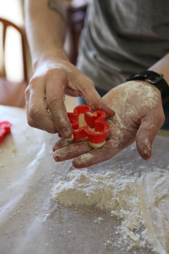 Sgt. Matthew Chorba removes dough from a cookie cutter at the Ronald McDonald House in Greenville, N.C., Dec. 13, 2014. Chorba, along with six other Marines with Marine Air Control Squadron 2, baked more than 200 cookies for the families living at the house. The Marines volunteered in an effort to give back to the community and spread holiday cheer to families in need. Chorba is a career planner with MACS-2. 