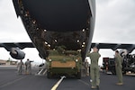 JOINT BASE PEARL HARBOR-HICKAM, Hawaii (Dec. 10, 2014) - Airman 1st Class Sean Bannan (middle right), from Seattle, Wash., a load master assigned to 535th Airlift Squadron, 15th Wing, ground guides a M1126 Stryker onto a C-17 aircraft to support of the 25th ID Contingency Response Force mission (CRF). The CRF mission is designed to rapidly deploy Soldiers within the Pacific's area of responsibility to provide humanitarian assistance and or combat operations.   141210-A-ZZZ00-695

