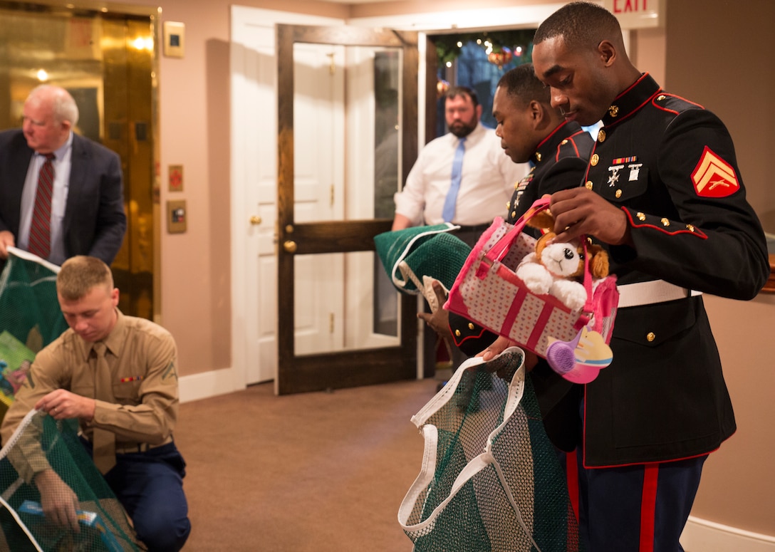 Marines with Headquarters Battalion, Marine Forces Reserve, pack donated toys at the Patrick F. Taylor Foundation building in New Orleans, Dec. 16, 2014. The toys were donated by employees of the foundation to support the Marine Corps Reserve’s Toys for Tots program.