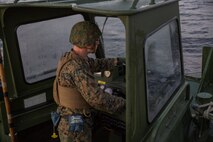 Lance Cpl. Walker Vance, a motor transport Marine with Bridge Company, 8th Engineer Support Battalion operates a boat attached to an Improved Ribbon Bridge aboard Marine Corps Base Camp Lejeune, N.C., December 14, 2014. Marines with the unit conducted river crossing exercises in which they transported M1A1 Abrams tanks across New River. (U.S. Marine Corps photo by Lance Cpl. Preston McDonald/Released)